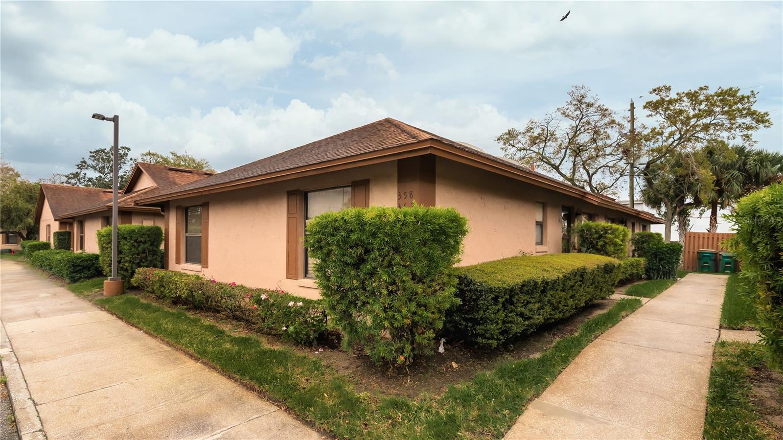 Charming end-unit residence in the well-established and ideally situated Town Homes of Winter Garden. Great opportunity for a first-time buyer, one who’s looking to downsize, or an investor. Layout features a great room that’s open to the kitchen, and a split bedroom (two suite) plan. The great room has a soaring ceiling w/skylight to bathe the space in light. Beautifully updated kitchen boasts granite counters, breakfast bar, attractive tile backsplash and stainless appliances. The primary bedroom is large enough for a sitting area or desk, and has an ensuite bath w/shower and walk-in closet. Secondary bath has two access points, giving the second bedroom direct access. Cozy covered patio is the perfect spot to set up a grill and enjoy outdoor dining. Two assigned parking spaces are right outside your building. BRAND NEW A/C installed May 2025 and comes with a 12 year transferable warranty to the new owner! BRAND NEW ROOF June 2025. The community has a pool so you can have a little fun in the sun. And your dues also include exterior maintenance (recently painted in 2024), landscape care, and exterior insurance/an umbrella policy – essential in the event of severe weather. Excellent location – Aldi is around the corner, and you can be at Publix in less than 5 minutes. You can be on the turnpike or SR 429 in less than 10 minutes. And you’re only a mile from the outstanding shopping and dining venues of desirable downtown Winter Garden. Come see all that this gem has to offer. Great deal!