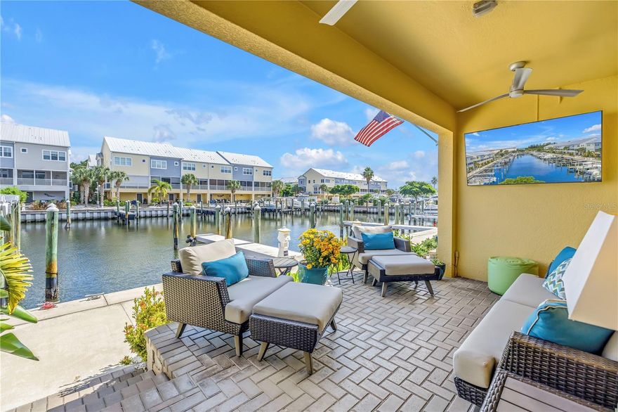 Architecturally designed for both beauty and function, the custom kitchen serves as the centerpiece of this waterfront townhome in The Cove at Loggerhead Marina — a private, gated community inspired by Key West charm. Experience refined coastal living at its finest in this impeccably upgraded residence, perfectly suited for boaters and nature lovers alike. The community is uniquely situated within the grounds of Loggerhead Marina, offering convenient access to its full-service marina and open waterways including Tampa Bay, Boca Ciega Bay, and the Gulf. This three-story home features a private elevator, 3 bedrooms, 2.5 baths, and a versatile bonus room ideal for a home office, den, or guest space. The main living level showcases an open-concept design with volume ceilings and the home’s bespoke, architecturally designed kitchen, featuring a 7-foot island, 42” cabinetry, quartz countertops, and premium stainless steel appliances including a built-in Thermador refrigerator/freezer and induction range. The adjoining living and dining areas flow seamlessly to a screened-in porch overlooking the water, where you can relax or entertain while taking in views of the marina and watching dolphins and manatees glide by. A custom stair railing with integrated gate extends throughout all levels of the home, adding both architectural character and functional design.Upstairs, the spacious primary suite offers tranquil water views, a cozy sitting area, walk-in closet, and a luxurious en-suite bath with dual vanities, a seamless walk-in shower, and a private water closet. Two additional bedrooms, a remodeled guest bath with custom vanity and walk-in shower (no tub), and a convenient laundry room complete the upper level. The oversized tandem two-car garage offers abundant storage for bikes, paddleboards, and beach gear. The extended lanai, equipped with outdoor televisions and speakers, provides the perfect setting for year-round entertaining. Enjoy peaceful water views and gentle breezes from this inviting space — ideal for unwinding at the end of the day or hosting friends in a relaxed coastal setting. Both the lanai and screened-in porch are equipped with outdoor speakers and televisions, enhancing every gathering — from quiet morning coffee to sunset cocktails. This property also offers peace of mind, having experienced no flooding during recent Hurricanes Helene and Milton. Community amenities include a resort-style pool with Tiki hut (equipped with cable TV and power), the Captain’s Lounge for gatherings, scenic walking trails, and community-wide mosquito control — all included in the HOA dues along with other covered services and utilities. Unbeatable location: just 8 minutes to vibrant downtown St. Petersburg, 10 minutes to world-famous St. Pete Beach, and 25 minutes to Tampa via I-275. Discover where coastal elegance meets effortless living — at The Cove at Loggerhead Marina.