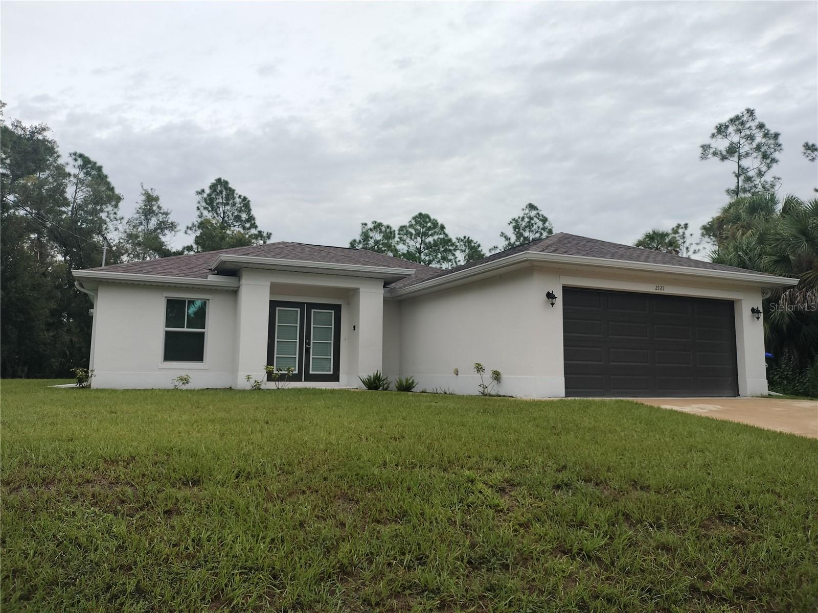 If it's peace and quiet you are seeking, then look no further! This perfectly placed home has everything that you have wanted in your next home! No front neighbors and no neighbors on either side. This four bedroom and two bathroom home is surrounded by beautiful wooded areas, but still close enough to your everyday conveniences. Double Front Doors open up to the well appointed and dramatically open great room and kitchen. Solid surface counters accented with modern Stainless Steel Appliances and Extra Large Island allows for dinner prep while the littles do their homework. Three way split on the bedrooms which gives everyone their own individual areas. The front room is the perfect size for an office or playroom and Bedrooms 2 & 3 flank the second bathroom on the opposite side. The Primary Bedroom has ample space for a King Sized bedroom set. There is a walk in closet and a en suite bathroom with a large stall shower and double vanity that rounds out this space nicely. The double car garage opens up to the inside laundry room that has enough room for additional storage for those that like to buy in bulk. Freshly painted, luxury Vinyl Plank, Whole house water softener and a great view from the patio all ensure that this home definitely has everything you want. Come take a look for yourself. You will not be disappointed!