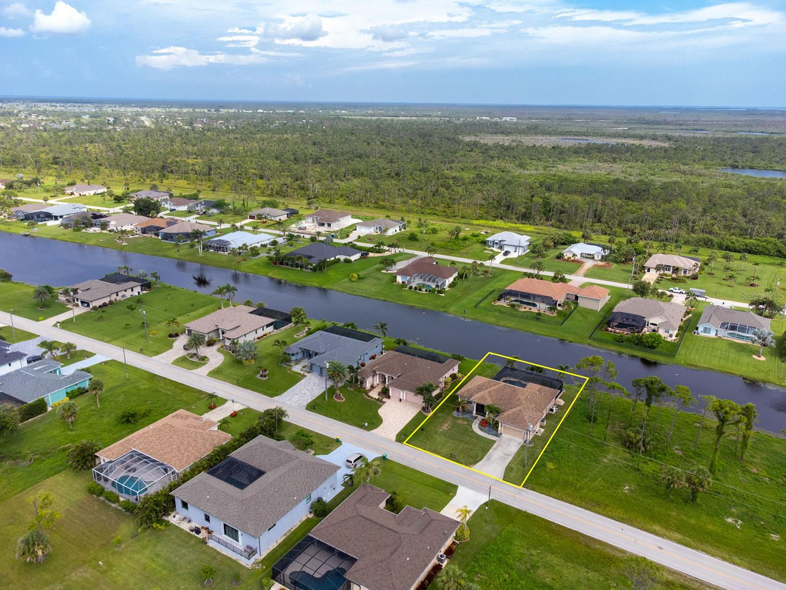 Experience the best of Florida living in this CUSTOM-BUILT, BREAKWATER CONSTRUCTION home in the sought-after community of Rotonda West, just minutes from pristine beaches, golf, and dining. Perfectly POSITIONED ON THE ROTONDA RIVER with peaceful views, this home offers an OPEN CONCEPT LIVING PLAN, three generous bedrooms and THREE FULL BATHS -- delivering exceptional comfort, privacy and style. Through striking design, dual glass entry doors, a GREAT ROOM welcomes you with an IMPRESSIVE COFFERED CEILING and an expansive kitchen with MARBLE-LOOK QUARTZ COUNTERTOPS and matching backsplash. Featuring an abundance of cabinetry and eating space, with a SUNNY BREAKFAST NOOK and COFFERED CEILING FLEX SPACE, there is ample room for entertaining and storage. Indoor living seamlessly transitions out through POCKETING-SLIDERS opening to an EXPANSIVE PAVER LANAI with an UPGRADED, CLEARVIEW screen cage, HEATED SALTWATER POOL with SUNSHELF + WATERFEATURE SPA (added in 2017). Overlooking a wide canal view with plenty of room for relaxation in the sun or shade, this oasis fulfills all your Florida dreams with a SOUTHERN FACING LANAI for sunrise skies and all-day sun on the pool then protected from late afternoon heat. The PRIMARY SUITE offers true reprieve with private lanai access, dual walk-in closets and an ensuite bath with SOAKING TUB, dual sinks, LARGE WALK-IN SHOWER and water closet. The guest quarters are tucked down a hall with convenient lanai access for the guest bathroom, second bedroom and a THIRD FULL ENSUITE BEDROOM. ADDITIONAL FEATURES to note include CUSTOM PLANTATION SHUTTERS and window treatments throughout, crown molding details, easy maintenance tile flooring in the living areas with cozy carpeted bedrooms, a dedicated INTERIOR LAUNDRY ROOM with sink and a multitude of storage closets. Outside, the property is surrounded by TROPICAL LANDSCAPING, custom concrete curbing and upgraded landscape rock all maintained easily with a SAINT AUGUSTINE LAWN IRRIGATED by the waterway at no additional cost. PEACE OF MIND COMES WITH WHOLE HOME HURRICANE PROTECTION and a high-and-dry elevation above flood plain (assumable flood insurance if desired.) Rotonda West provides an aesthetically pleasing neighborhood with low fees and convenient access to five nearby golf courses, a central park with playground, tennis courts, RV/boat storage and is just minutes away from the beautiful beaches of Boca Grande and Manasota Key! Schedule your showing today to experience the quality, style, and elegant Florida lifestyle this property offers! FURNISHINGS AVAILABLE TO BE NEGOTIATED VIA SEPARATE CONTRACT.