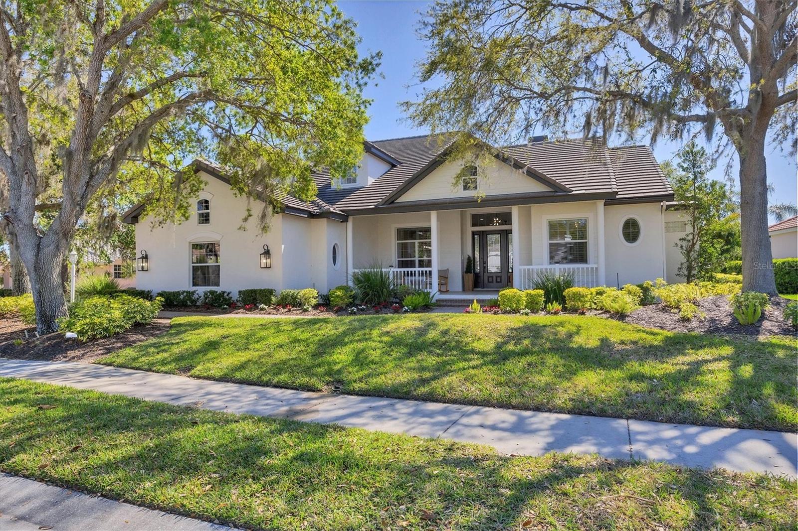 Luxury Living on the Fairway, 6540 The Masters Avenue 2-story home in Lakewood Ranch is sold furnished and ready for immediate occupancy. Nestled in the highly sought after community of Lakewood Ranch Country Club, this stunningly updated estate home offers an unparalleled blend of elegance and modern convenience. Overlooking the sixth hole of The Legacy Golf Course, this 5-bedroom, 4-bathroom home, complete with a large second floor bonus room and dedicated office with french doors, delivers breathtaking golf course views and refined indoor-outdoor living. Step inside to discover a fully renovated interior, where new engineered wood flooring flows throughout the open-concept layout on the first level. The chef’s kitchen is a masterpiece, featuring new cabinetry, quartz counters, GE Monogram appliances and island with seating...perfect for entertaining. The outdoor space is a true showstopper, with a newly resurfaced and retiled pool, updated panoramic pool screens, and brand-new pavers enhancing the expansive lanai. Enjoy Florida’s year-round sunshine in your new summer kitchen, ideal for al fresco dining while soaking in the picturesque golf course views. With a newer roof (2018), new electronic blinds and recent exterior and interior paint, this home is move-in ready and designed for effortless luxury. All the closets have custom built in cabinetry and primary closet has extra room for large safe. All bathrooms were updated in 2022, including the half bath in the lanai. Enjoy the front porch with matching rocking chairs for early morning coffee or evening glass of wine. The side load, 3-car garage has epoxy floor and extra storage room in a loft space above! Don't miss this rare opportunity to own an exquisite golf course retreat in one of Lakewood Ranch’s most coveted communities with the low HOA fees of $150 a year! Convenience is key, located just minutes to Waterside, UTC, Interstate 75, the beautiful beaches of Sarasota and Sarasota/Bradenton airport! Hurry in and make this house your next home sweet home!