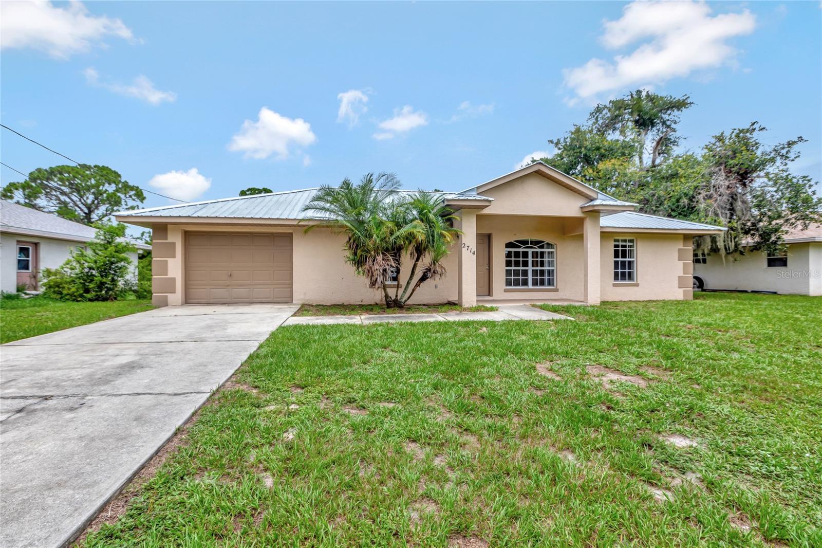 Welcome home to this charming and well-maintained 3-bedroom, 2-bath ranch-style home nestled in a friendly and walkable neighborhood. New metal roof in 2024! Ideally located near schools, shopping, and a variety of local restaurants, this home offers both comfort and convenience. Step inside to a functional single-level layout featuring durable tile floors throughout, a spacious living area, and a cozy dining space perfect for everyday meals or casual gatherings. The charming galley kitchen offers efficiency and style, with easy access to the dining area for seamless entertaining. Relax and unwind on the screened-in back porch overlooking the large backyard—ideal for pets, gardening, or weekend BBQs. A one-car garage adds convenience with secure parking and extra storage. This move-in ready gem is perfect for first-time buyers, downsizers, or anyone seeking a low-maintenance lifestyle in a welcoming community. Don’t miss your chance to make it yours!