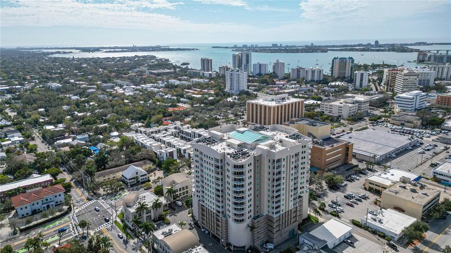 Enjoy sweeping, panoramic views of Sarasota from this luxurious, completely renovated penthouse in Rivo at Ringling. This distinctive condominium, renowned for its unique style, interior atrium, and upscale amenities, offers a lifestyle of unparalleled sophistication. Previously featured in Style and Sarasota magazines, this residence was expertly redesigned by renowned designer Cox, Kliewer and Company and built by DTI Construction's Dean Thompson. With 3-bedrooms, den, office 3.5-bathrooms, 3,365 sq. ft. this residence occupies the coveted southeastern corner, bathing the space in morning sunlight with captivating vistas of downtown Sarasota and the bay from the two balconies. The renovations have transformed this penthouse into an open and airy haven, accentuating unobstructed sightlines to breathtaking views. The living room and kitchen have been reconfigured to create an open, architecturally interesting space adorned in neutral tones that radiate relaxation and tranquility. The kitchen, a culinary enthusiast's dream, features a custom stainless-steel backsplash, Brazilian anigre wood cabinetry, SubZero, Miele and Bosch appliances, Perlick wine cooler, a professional stainless steel island top with two sinks both with Everpure water filtration and custom pantry built-ins. Hans Grohe fixtures in the kitchen and master bathroom.  The spacious owner's suite has a large custom closet, private balcony and en suite bathroom w/garden tub and walk-in shower. Corsican Crème porcelain tile enhances the residence's light, open ambiance with a touch of elegance. Other upgrades include ambient lighting, solid wood moldings, new doors and extensive custom closets. Includes two parking spaces on the first floor of the garage and an extra-large storage room right in front of the parking spaces. This contemporary tower provides easy access to downtown Sarasota's offerings while offering a peaceful retreat from the hustle and bustle. Fine dining, boutique shopping, and entertainment are minutes away. The third-floor amenities, including a heated pool, spa, outdoor grill, state-of-the-art gym, social room, and a convenient bike room, enhance the luxurious living experience. Rivo residences are highly coveted, and this rare, sophisticated penthouse presents an exceptional opportunity to claim your place in this exclusive community. Don't miss the chance to call this meticulously designed residence your home.