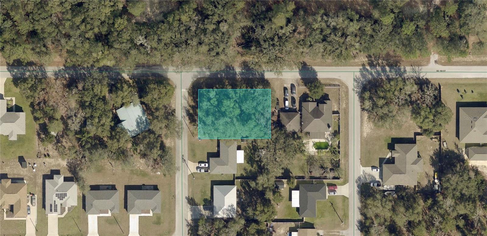 Just north of the Villages in an upscale neighborhood with many newer site built homes! This is Marion County PARCEL 4714-208-030. NO flood zone to worry about, on a paved road, and just off of Highway 441 for your convenience. Home values in the neighborhood are mostly around $350,000 and rising. Orange Blossom Hills subdivision. No HOA dues / rules. Get in now! People are moving inland like crazy to get away from the hurricanes. The street address was created only for mapping purposes and is not an official street address. For driving directions, you may also copy and paste these GPS Coordinates in Apple or Google Maps: 29.003704, -81.999589. Can also use neighbor to the left when facing the properties address for directions: 9292 SE 150th Pl, Summerfield, FL 34491.