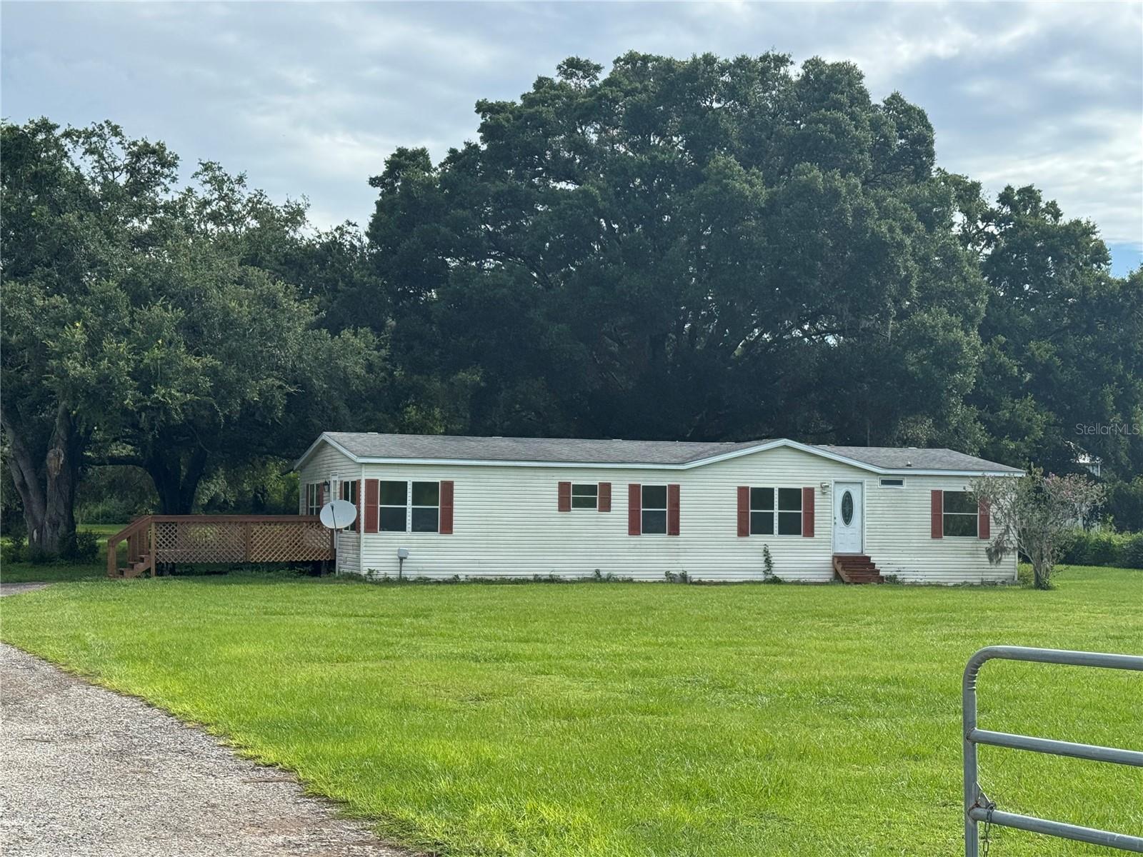Looking for peace, privacy, and room to roam? This charming 3-bedroom, 2-bath mobile home offers 1,792 sq. ft. of comfortable living space, set on a 6-acre lot with majestic oak trees. Inside, you'll find a well-maintained layout perfect for relaxed country living. Outside, enjoy the versatility of a large 20x40 barn—ideal for storage, hobbies, or workspace. Experience the best of quiet living while still being within reach of local conveniences. One time admin fee of $150.00