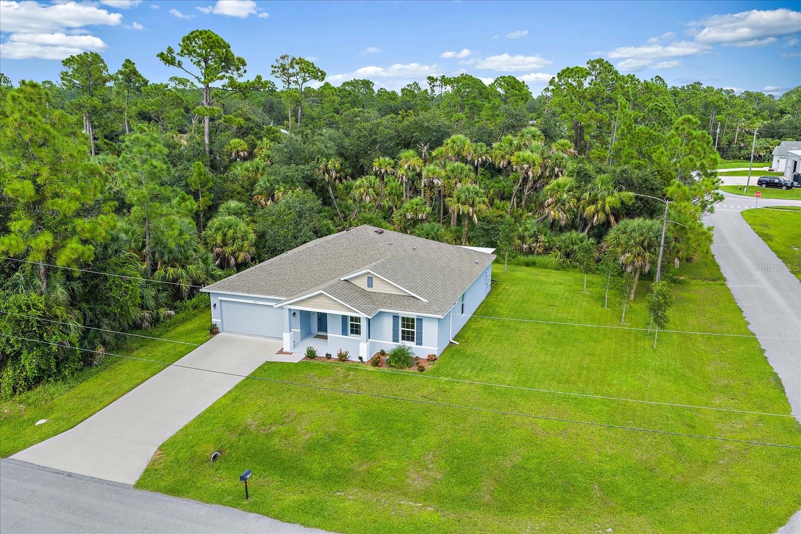 One or more photo(s) has been virtually staged. Step into modern comfort and design with this never lived in four bedroom, two bathroom home that is packed with upgrades! Situated on an oversized corner lot, this property provides extra space and wonderful privacy, surrounded by trees. Located in North Port, Florida, a blooming community where you’ll enjoy the benefits of a thriving area without the restrictions of an HOA or CDD, with the addition of not being in a flood zone. To top it all off, this home is offered at a great price, making it an incredible value for a brand new build!
Inside, you’ll find a bright, open floor plan with tile flooring throughout and all appliances included. Smart home capabilities bring convenience to your fingertips, while upgrades such as a whole home water softener system add long term value and comfort. The spacious living and dining areas flow into a screened in lanai, perfect for relaxing or entertaining while overlooking the natural setting. The split floor plan ensures privacy for the primary suite, while the additional bedrooms provide flexible space for family, guests, or a home office. The garage has also been upgraded with a durable epoxy coating for both style and functionality.
The location adds even more appeal. Downtown Wellen Park is just 14 miles away, offering dining, live music, markets, and family friendly events. Everyday shopping and dining are only 6.1 miles away at Cocoplum Plaza. Sports enthusiasts will appreciate being just 15 miles from the Atlanta Braves Spring Training Complex. For relaxation, the world famous Warm Mineral Springs is less than 10 miles away. With I-75 under 4 miles from your doorstep, commuting and exploring the Gulf Coast couldn’t be easier.
This home blends extra space, privacy, modern upgrades, and an unbeatable value, all in a rapidly growing and vibrant community. Don't miss this truly special opportunity to move right into a brand new home. Skip the wait and start living the lifestyle you’ve been dreaming of!