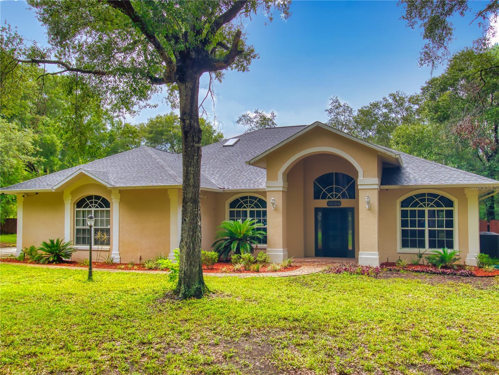 Enjoy the best of both worlds—country living just minutes from town! This beautifully maintained 3-bedroom, 2-bath concrete block home sits on a high 1-acre lot offering privacy, tranquility, room to grow and endless possibilities. With over 2,800 sq ft of living space, an open floor plan and high cathedral ceilings this home is perfect for family, entertaining or enjoying peaceful evenings by the wood burning fireplace. The quality tropical lagoon-style pool is ideal for relaxing, enjoying family time or hosting gatherings while the oversized 2-car garage provides ample storage. Zoned for versatility—bring your RV, horse, or dreams of a garden. There's also potential to add an accessory dwelling if desired. Enjoy the charm of rural living without sacrificing proximity to shopping, dining, and schools. A rare combination of peaceful rural charm and close-to-town convenience—don’t miss this one!