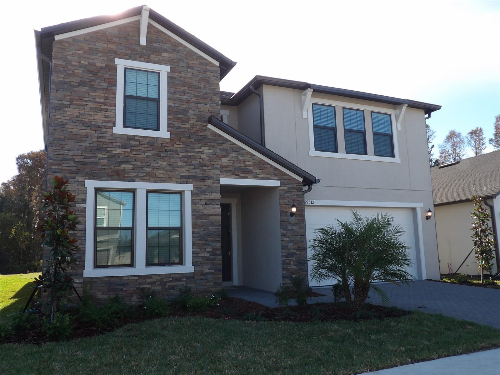 This modern two-story home features an open-concept plan connecting the main living spaces and covered patio. The owner’s suite enjoys an ideal location on the first floor, along with a flex room for versatility. There is also a guest bedroom on first floor with ensuite. Upstairs, three secondary bedrooms surround a loft, complete with beverage center for entertaining. One bedroom on second level has an ensuite. This home is located in the desirable Connerton community. Residents have access to exciting amenities, including two pools - a resort-style pool with a splash park and a competitive lap pool, multiple sport courts, multiple sport courts, miles of trails for walking, jogging, and biking, as well as an onsite elementary school. The local area boasts extensive shopping, dining and entertainment venues. Available for move in on 11/1/2025