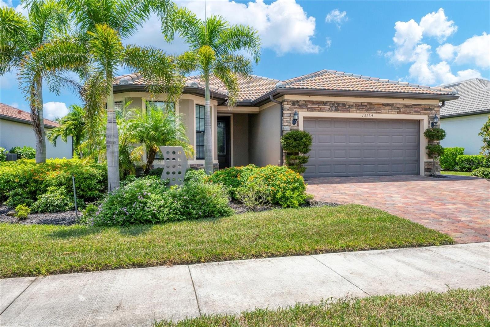 Welcome to this 3 bedroom 2 bath Abbeyville model built by Divosta. This meticulously maintained home (only one owner) has been used as a seasonal home, (6-8 weeks a year). The open-concept floor plan offers an easy flow of living. Some of the upgrades include tall doors, luxury vinyl flooring in the bedrooms, tile flooring throughout the rest of the home, a kitchen that offers plenty of space to cook and gather with family and friends. The primary suite offers views of a natural wildlife preserve, a bathroom with a dual vanity and an oversized shower. There are block out up-down shades throughout the home. There are several closets for storage and a large laundry room. The garage features an insulted door/ceiling, has a sink and a workbench. The screened in den also has panoramic views of Florida's natural vegetation and wildlife. The outside of the home is enhanced with attractive stone siding, a widened driveway and landscaped with foxtail palm trees and other native plants. The Island Walk community is centrally located in Welland Park. This resort style living offers an abundance of amenities. Residents enjoy lakes, bridges, and natural surroundings, as well as year-round events organized by a full-time activities director. The HOA provides maintenance-free living, three community pools, pickleball and tennis courts, a fitness center, social clubs and a community room, along with exterior maintenance like trimming, mulching, and mowing. There is a 24-hour staffed security gate, and a fully staffed onsite HOA office. This home is conveniently located close to downtown Wellen Park where you can find shopping, dining, local business, outdoor concerts, a weekly farmers market and a community lake. Island Walk offers quick access to US-41, Tamiami Trail, and I-75 the Gulf beaches and historic Venice Island. Sarasota airport (55 minutes) Punta Gorda airport (45 minutes) and Ft Myers airports (1 hour) are all within an easy drive. Call today to schedule a showing!