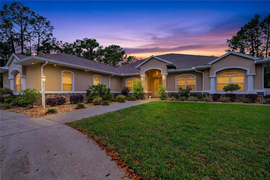 Welcome to 4052 N Mayan Drive in desirable Fairview Estates in Hernando—a stunning 3-bedroom, 3.5-bath luxury home offering nearly 5,000 square feet of living space on a private 1.17-acre corner lot. One of the largest homes in the neighborhood, this residence combines grand scale, thoughtful design, and seamless indoor-outdoor living. A semi-circular driveway creates an impressive arrival. Inside, the grand foyer immediately draws your eye to the pool and spa, setting the tone for the home’s open, airy feel. The front living room features a fireplace and dramatic corner sliding glass doors that fully open, creating a wide, unobstructed transition to the outdoor living space. A spacious dining room provides the perfect setting for entertaining. The oversized kitchen is both functional and beautiful, showcasing rich cabinetry, large solid surface countertops, an island with sink, sleek cooktop, double ovens, and under-cabinet lighting. The breakfast nook is filled with natural light and offers tranquil pool views. The family room is generously sized with sliders to the pool, while the expansive recreation room provides ample space for a billiards table, seating area, and more—also with direct outdoor access. Perfect for entertaining. The primary suite is a true retreat, featuring French doors to the pool, dual walk-in closets, and a luxurious bath with soaking tub, walk-in shower, dual vanities, and private water closet. One guest bedroom is configured as an en suite with private bath and walk-in closet, while the second guest bedroom is oversized with its own walk-in closet.    The outdoor living area features a spacious pool deck with outdoor shower, pool, and spa—perfect for relaxing or entertaining.  Additionally, there is a convenient half bath within the pool enclosure. Additional highlights include a dedicated office, home gym, large laundry room with abundant cabinetry and utility sink. Recent improvements include updated AC/heat pumps (2022), pool pump and heater replacements, mini split in the garage, irrigation system updates, and conversion of a small garage into a climate-controlled gym. Complete with a 2-car garage and expansive lot, this exceptional home offers space, privacy, and a true Florida lifestyle.