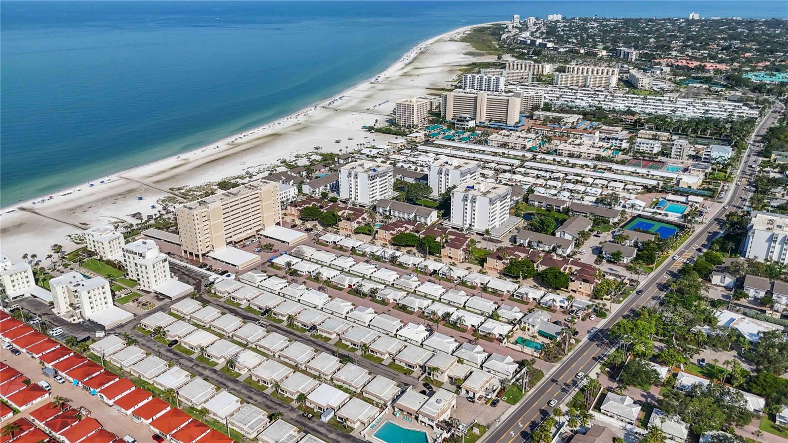 A rare investment opportunity awaits with this proven income-producing property on world-renowned Siesta Key Beach. Located within the beautifully maintained Island House Beach Resort, this unique offering includes two units in one building, complete with a two-car carport and additional storage. Flexible rental options allow it to be used as a full 4-bedroom rental, two separate 2-bedroom units, or you can live in one and rent the other—offering excellent versatility and income potential. Recently renovated, the property features hurricane-impact windows, 3M-tinted sliders, and is being sold turnkey furnished for immediate use. Enjoy private beach access with cabanas, beach chairs, and lounges, just a short walk from your doorstep. The resort also offers a spacious beachside courtyard with patio seating, gas grills, and shuffleboard courts—perfect for relaxing or entertaining. The recreation center includes a full-length heated swimming pool, pool table, ping pong, and air hockey, providing plenty of options for fun and relaxation. Ideally located just minutes from Siesta Key Village, downtown Sarasota, and steps from the sand, this is your chance to own a slice of paradise with excellent income potential.
