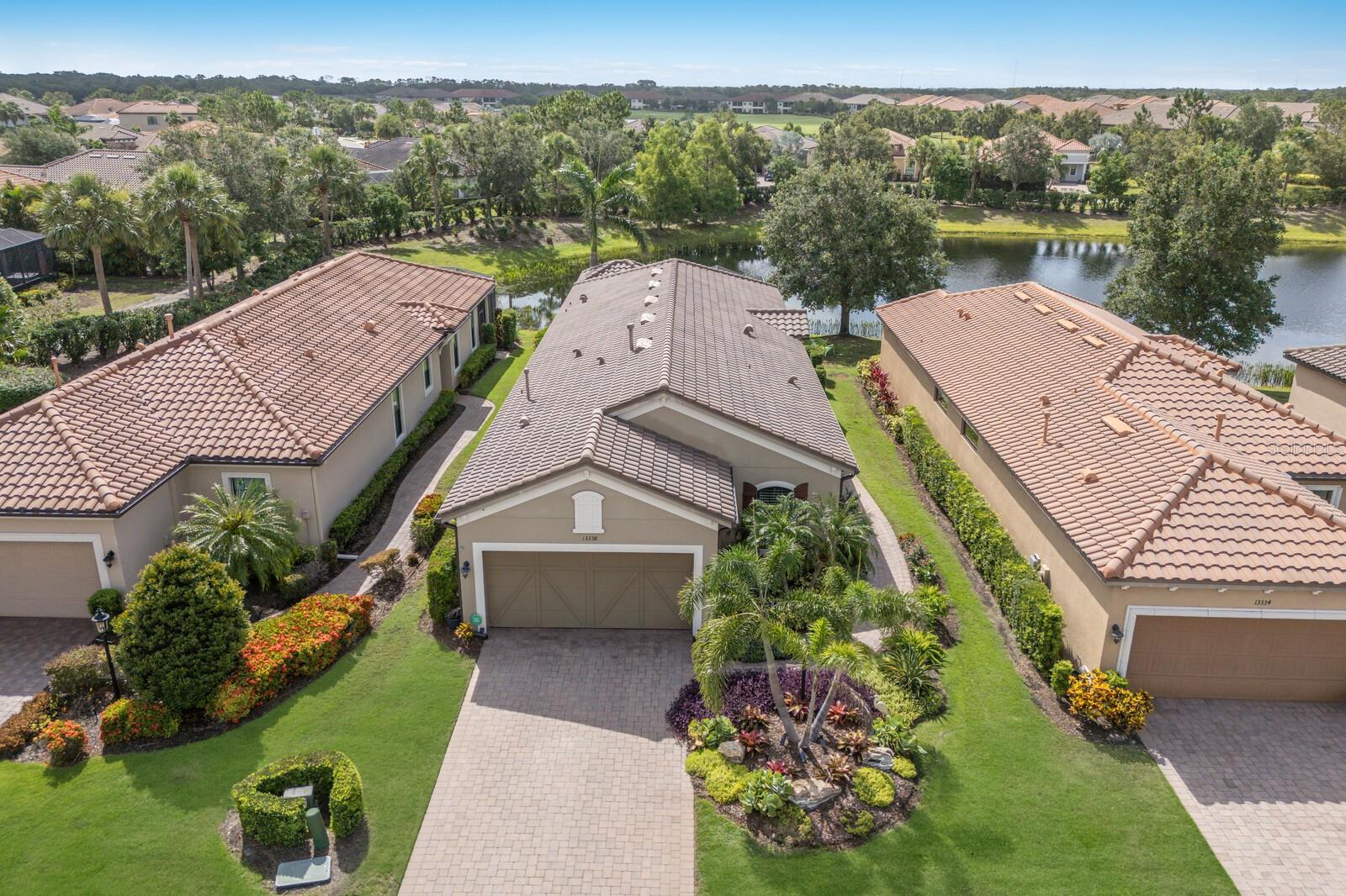 Welcome to Resort-Style Living in Esplanade Golf & Country Club at Lakewood Ranch. Discover the joy of maintenance-free living in this beautifully upgraded and lovingly maintained home, situated on a quiet cul-de-sac with breathtaking sunrise water views. Whether you are starting your morning or unwinding with your favorite beverage, your private in-ground heated spa provides the perfect spot to relax and recharge. Step onto the extended lanai, a true outdoor oasis, designed for entertaining and everyday enjoyment. Featuring a fully equipped outdoor kitchen with a built-in grill, beverage cooler, and cozy gas fireplace, this space is ideal for gathering with family and friends or enjoying a quiet evening under the stars. The professionally expanded landscaping adds an extra touch of serenity and curb appeal, creating a truly tranquil environment. Inside, the highly sought-after Arezzo floor plan offers 1,912 square feet of thoughtfully designed living space. The home features three spacious bedrooms, two full bathrooms, and a flexible office/den, all set within a bright, open-concept layout. The split floor plan offers ideal privacy, while the gourmet kitchen will inspire your inner chef with 42" cabinets, crown molding and under-mount lighting, granite countertops, tile backsplash, gas stove, stainless steel appliances, wine fridge, and a generous pantry. Retreat to the owner's suite, where the spa-like en-suite bath includes dual sinks, a vanity and a luxuriously oversized custom closet with abundant shelving and built-in chest of drawers. Additional thoughtful touches include tray ceilings, crown moldings, built-in Sonos indoor & outdoor speakers, custom shelving in every closet, upgraded window treatments, and elegant tile flooring in the bathrooms and laundry room. The extended 2 car garage with epoxy floor provides plenty of extra space with large built-in storage cabinets and the attached easy-close hurricane shutters offer added peace of mind. Plus, the HVAC was just replaced in 2025! Living in Esplanade truly feels like being on vacation every day. Enjoy access to the zero-entry resort-style pool, strengthening resistance pool, 12,000 sf clubhouse, challenging 18-hole golf course, wellness and fitness centers with instructor-led classes. There are endless opportunities for recreation, from pickleball tennis to bocce ball and kayaking. Golf is not included in the HOA fees; however, club members can easily pay to play. This amenity-rich community also features an on-site salon and the Koquina Sand Spa for your personal pampering. Social life is vibrant and welcoming, with clubs, events and activities curated by a dedicated lifestyle director. And when it is time to dine, you will love the options at The Barrel House Bistro, the poolside Bahama Bar & Café, and the Culinary Center, which also offers cooking classes and catering services. Live in the most sought-after master-planned communities in the US, boasting A-rated schools and conveniently situated mere minutes from the vibrant UTC shopping and dining area, SRQ Airport, downtown Sarasota and its breathtaking world-class gulf coast beaches. This is not just a home...it is a lifestyle you will fall in love with, one relaxing day at a time.