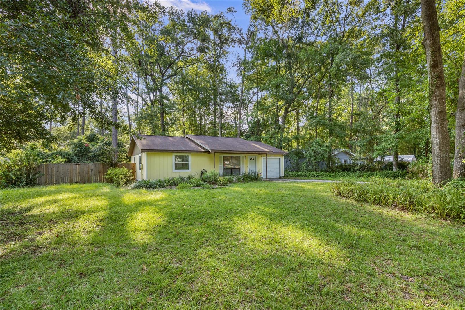 This well-maintained 3-bedroom, 2-bathroom home offers 1,245 sq ft of comfortable living space, perfectly situated on a spacious, nearly half-acre lot. Ideal for families, entertainers, or anyone looking for a peaceful retreat with room to grow. Step inside to find a functional layout with tasteful updates and plenty of natural light. Solid surface countertops in the kitchen along with abundant cabinets and stainless steel appliances, make this kitchen very functional for the chef in your life. A portion of the garage has been thoughtfully converted into a dining room, adding extra living space, while the remaining section serves as a convenient storage area. Enjoy outdoor living at its finest with a oversized storage shed, fully fenced backyard and a large wood deck—perfect for family gatherings, BBQs, or hosting friends. Water Heater replaced in 2023. Washing machine new in 2024.