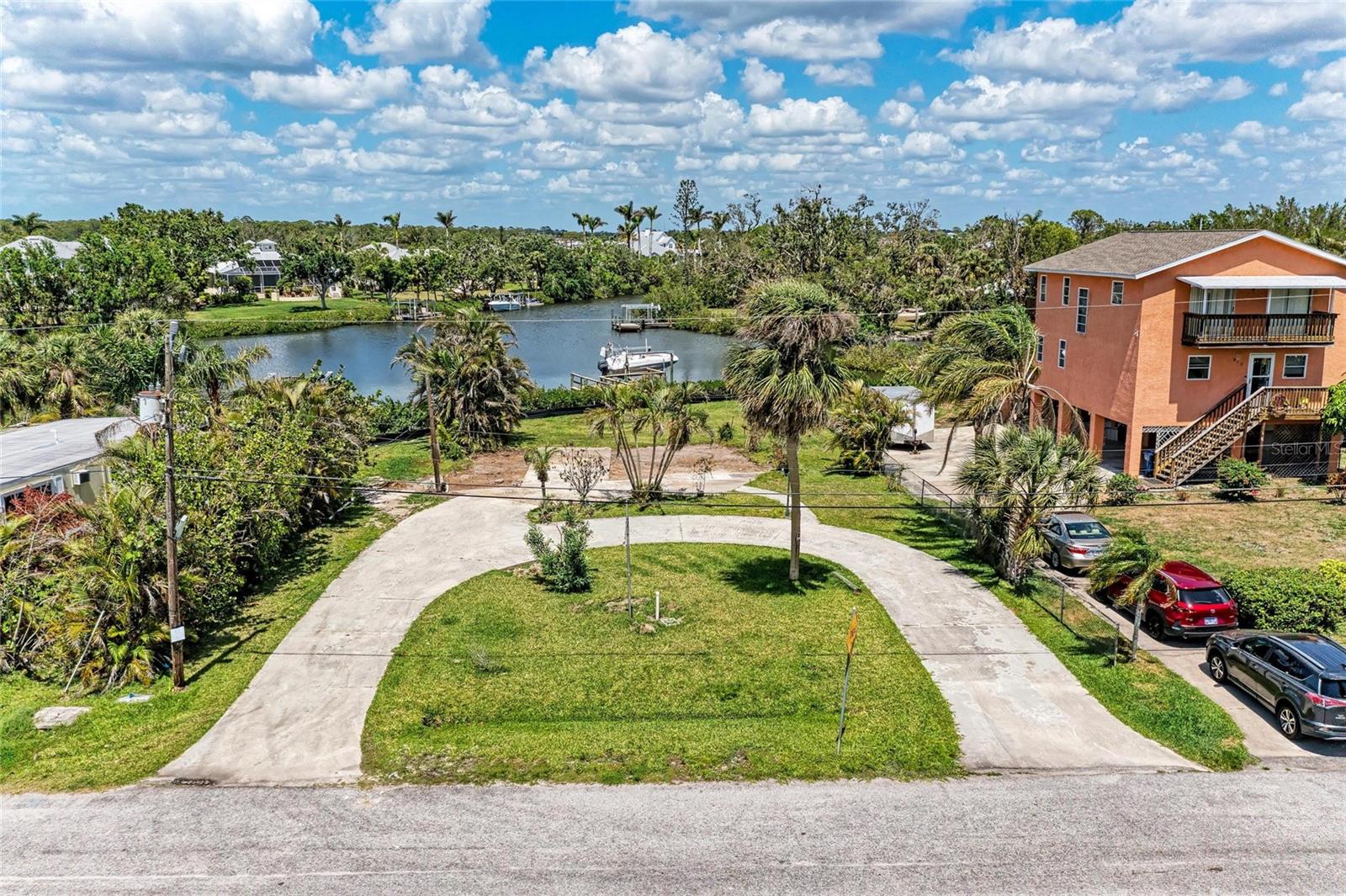 Build your dream home on this magnificent property that has Gulf access and beautiful wide views of Shakett Creek. 3 miles to the Gulf! Straight shot to the Venice Jetty! Prime boating area! This unique property has a boat dock and 7,000 pound boat lift with electric, built in 2007. This maintained and nicely landscaped lot has a circular driveway and is located on a dead-end street of a residential area. Sunset colors on the bay are gorgeous every night! Paddleboard and canoe right from your dock! There are not many boating water-access properties for sale anymore, so hurry up and get yours today! Close to our beautiful beaches, shopping, dining and easy access to Venice and Sarasota. Well is in good condition. Needs a septic.