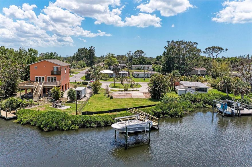 Build your dream home on this magnificent property that has Gulf access and beautiful wide views of Shakett Creek. 3 miles to the Gulf! Straight shot to the Venice Jetty! Prime boating area!  This unique property has a boat dock and 7,000 pound boat lift with electric, built in 2007.  This maintained and nicely landscaped lot has a circular driveway and is located on a dead-end street of a residential area. Sunset colors on the bay are gorgeous every night! Paddleboard and canoe right from your dock! There are not many boating water-access properties for sale anymore, so hurry up and get yours today! Close to our beautiful beaches, shopping, dining and easy access to Venice and Sarasota. Well is in good condition. Needs a septic.