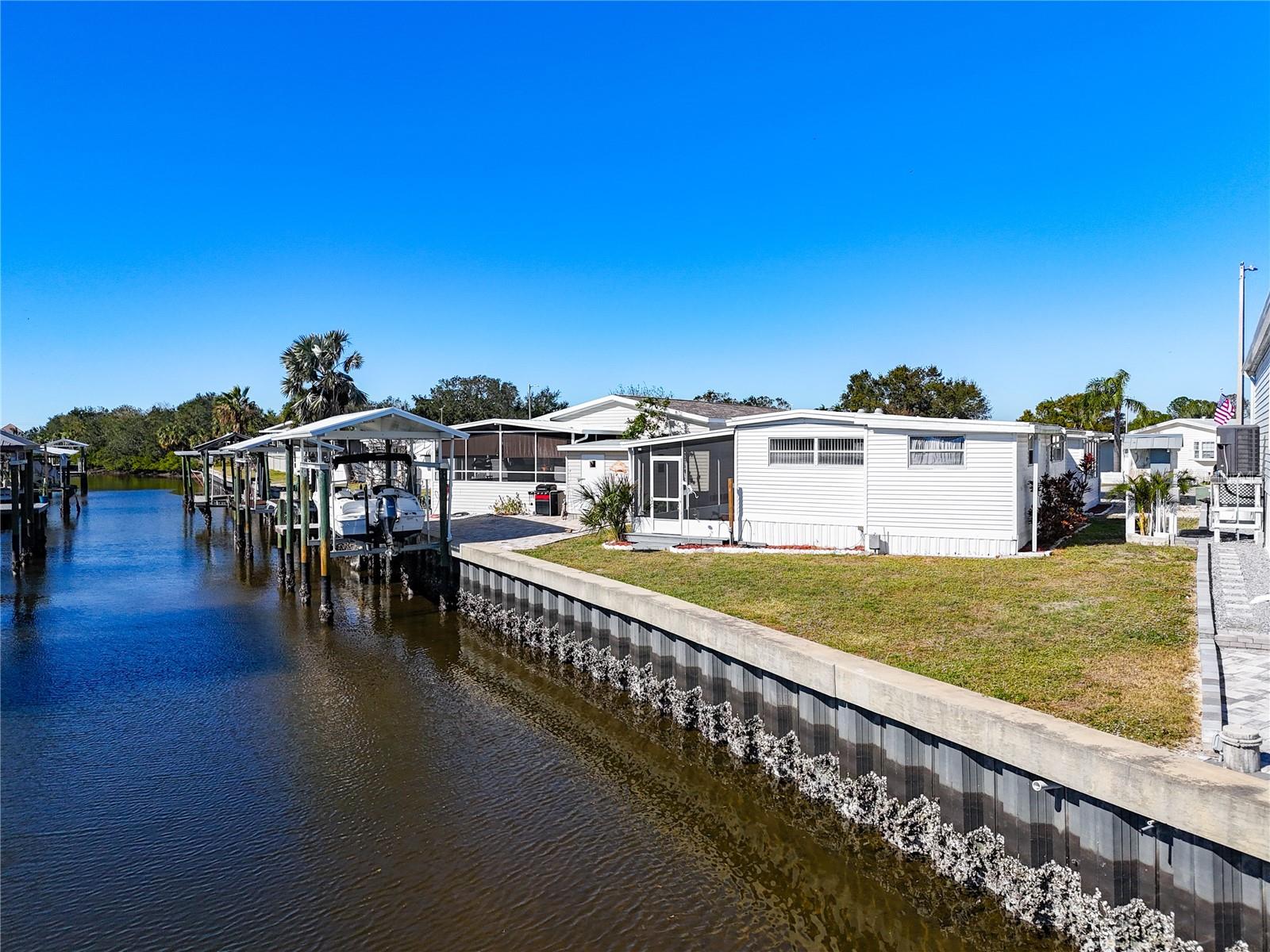 HUGE PRICE IMPROVEMENT! Owner says bring us an offer! Canal Living at it's best! Updated charming 2BR/2BA home in Caribbean Isles Residential Cooperative on a canal that leads directly to TAMPA BAY! During the winter months enjoy watching the manatees and dolphins from your back porch! The primary bedroom and bathroom have been tastefully updated with new flooring and fixtures. Laundry room off the ensuite has also been updated and includes a washer and dryer that are only a year old! Both bedrooms have large closets. Kitchen is HUGE! All new appliances and countertops along with solid wood cabinets make the kitchen a joy to cook and entertain in. Caribbean Isles is a very active 55+ cooperative. Activities include but are not limited to Bocce Ball, shuffleboard, horseshoes, large craft room with 2 kilns, well stocked and maintained library and a large HEATED pool for your enjoyment year round. In season, dancing and dinners are a frequent occurrence. Bingo and many other games are played at the clubhouse. Caribbean Isles also has a large RV/Boat storage lot for a small fee to reserve a space. There is a community boat and kayak launch, not to mention, great fishing from your own backyard! Caribbean Isles is conveniently located near many shops and restaurants, as well as I-75 for an easy commute into Tampa. Enjoy the Florida lifestyle and make this your new home!