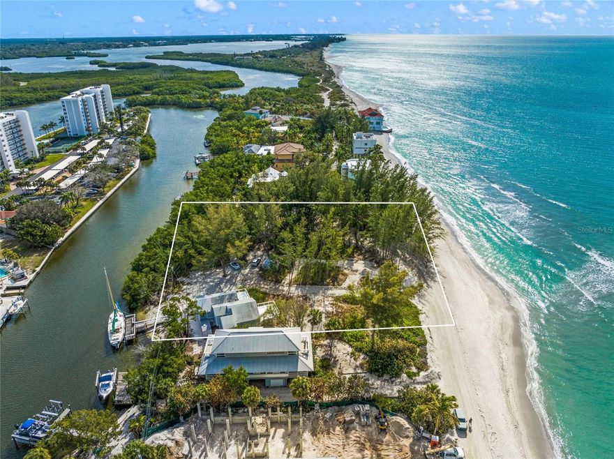 Rare opportunity,  Spectacular 1.1 acres situated on the Gulf of Mexico ~ 172 feet of Gulf Frontage with Sailboat water on the rear of the property with dock! Nestled amongst the pines and natural vegetation on secluded Blind Pass, you experience the forgotten charms of the Florida coast. Miles of sand and crystal clear Gulf waters surround this nostalgic 3 Bedroom/ 3.5 Bath home. Offering access to sailboat waters as well as a private beach on the Gulf of Mexico, this home offers the best of both worlds and is rarely available. This 2 story home is filled with natural light from the massive windows throughout. The multiple decks allow for views of the water from all angles where one can enjoy the warm Gulf breezes, breathtaking sunsets and host family and friends. Loft style living, this home has plenty of space to relax and enjoy the beach lifestyle. This home is close to being a tear down.... you may have an opportunity to add your own special touches to this home or see your vision become reality and build your dream estate. This acreage and its location are second to none and would be the perfect setting for a coastal sanctuary for those who seek refinement and seclusion. Tucked away from the hustle and bustle, this home is only a short drive to fabulous shopping, exquisite restaurants, medical facilities and everything that the Sarasota area has to offer. It’s time to answer the call of the sea and make your coastal dreams a reality.