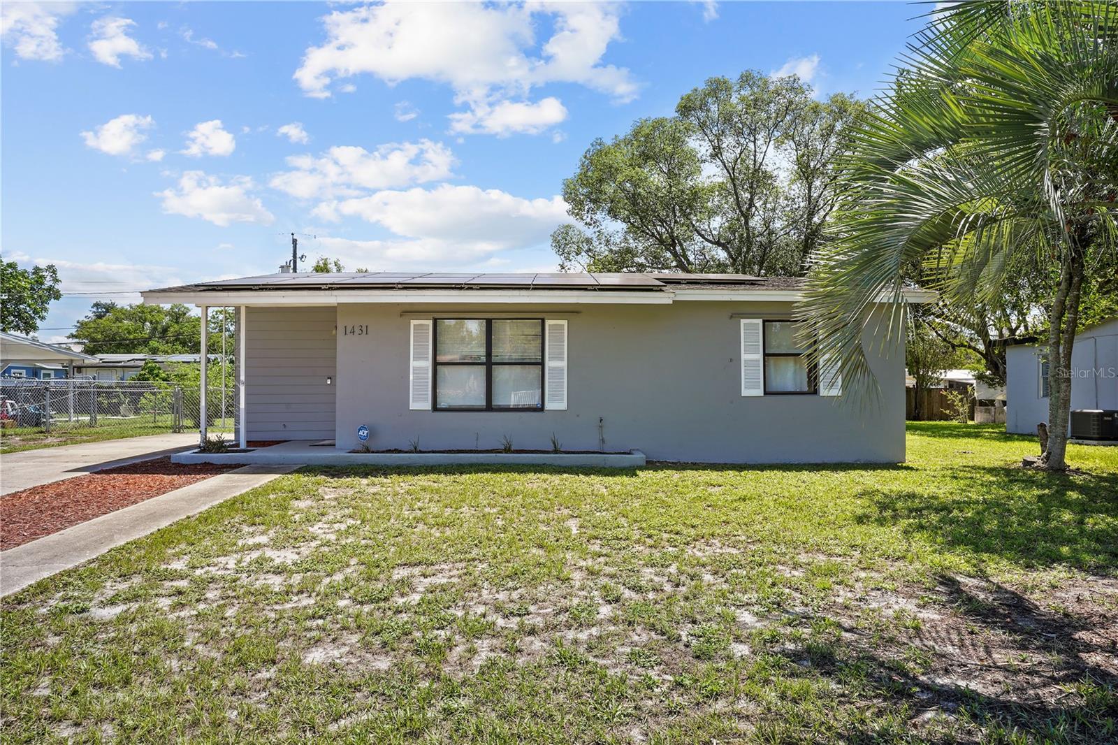 Move-in ready and fully updated, this 2-bedroom, 1-bath home at 1431 N Normandy Boulevard in Deltona delivers modern style and energy-smart living in one inviting package. A 2020 refresh introduced a bright, open-concept layout that connects the main living area with a contemporary kitchen appointed with crisp cabinetry and gleaming granite countertops—perfect for meal prep, morning coffee, and casual gatherings. New laminate flooring runs seamlessly throughout, creating a durable, low-maintenance foundation for everyday life, while fresh interior and exterior paint adds a clean, cohesive look from curb to kitchen. Comfort continues in the bedroom wing with two well-proportioned rooms and a tidy full bath. Thoughtful storage and a neutral palette make it easy to move right in and make the space your own. Energy-conscious buyers will love the solar panels, helping to reduce monthly electricity costs and offer more predictable utility spending. Out back, a spacious backyard sets the stage for weekend barbecues, lawn games, or future garden beds—without HOA rules to limit your vision. Whether you’re purchasing your first home, simplifying your lifestyle, or adding to an investment portfolio, you’ll appreciate the combination of updated finishes, efficiency, and flexibility. Enjoy the Central Florida lifestyle with beaches approximately 20 minutes away, along with convenient access to Deltona’s local shopping, dining, and everyday essentials. With its 2020 updates, open-concept design, and energy-saving solar, this home stands out as a savvy value in a prime location. Don’t miss out—schedule your showing today!