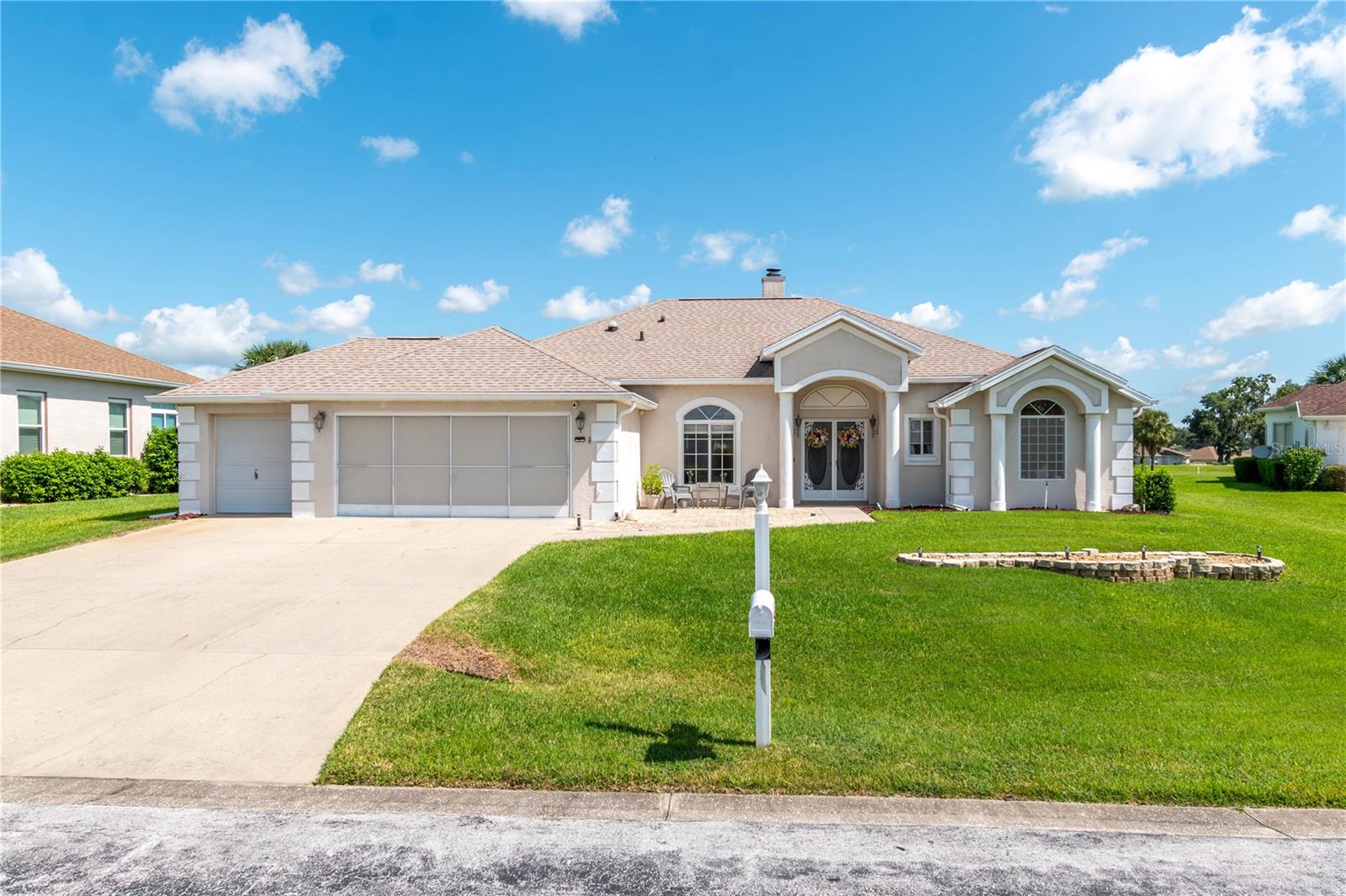 Discover effortless Florida living in the gated 55+ golf community of Ocala Palms. Set along the 9th and 18th holes of the community’s lush golf course, this well-maintained 3-bedroom, 2-bath home offers 1,796 sq ft of thoughtfully designed space and a prime position. The spacious front paver patio offers plenty of room to sit back, relax, or catch up with neighbors, with easy-care landscaping that keeps maintenance simple. Inside, high ceilings and a split-bedroom layout balance open living spaces with private retreats. The living room is bright and inviting, featuring abundant natural light, a cozy gas fireplace, and sliding glass doors leading to the rear patio. Designed for those who love to cook or entertain, the kitchen features generous cabinet storage, matching appliances, and a central island with breakfast bar. A passthrough window connects easily to the Florida room, making hosting seamless. At the rear of the home, a secondary family room offers direct backyard and golf course views, framed by an elegant arched entry and highlighted by a tray ceiling. It's an ideal space to unwind or entertain, with built-in surround sound speakers extending throughout the home and garage—perfect for music, movies, or game-day energy. The primary suite is a private retreat with tall tray ceilings, direct access to the Florida room, a large walk-in closet, and a spa-style en-suite bath featuring dual vanities, a glass-enclosed shower, a garden tub, and a second walk-in closet. The Florida room is a true centerpiece for entertaining, equipped with a full summer kitchen including a mini-fridge, flat cooktop, sink, and bar seating. With space to gather, dine, or enjoy golf course views in comfort, it’s a seamless extension of the living area. Just beyond, the expansive paver patio adds even more room for outdoor seating or weekend barbecues. Additional highlights include an indoor laundry room with built-in cabinets and a utility sink, plus an oversized 2-car garage with a dedicated golf-cart bay, generator panel, newer water heater, garage screen sliders, and full surround sound. Residents of Ocala Palms enjoy access to an array of amenities including an 18-hole golf course, indoor and outdoor community pools, a fitness center, multiple recreational courts, and an active clubhouse that supports a vibrant lifestyle. Shopping, dining, and entertainment are just minutes away, with the renowned World Equestrian Center located less than 10 minutes away for year-round equine events. Whether you're seeking a full-time residence or a seasonal escape, this home blends comfort, convenience, and community in one impressive package.