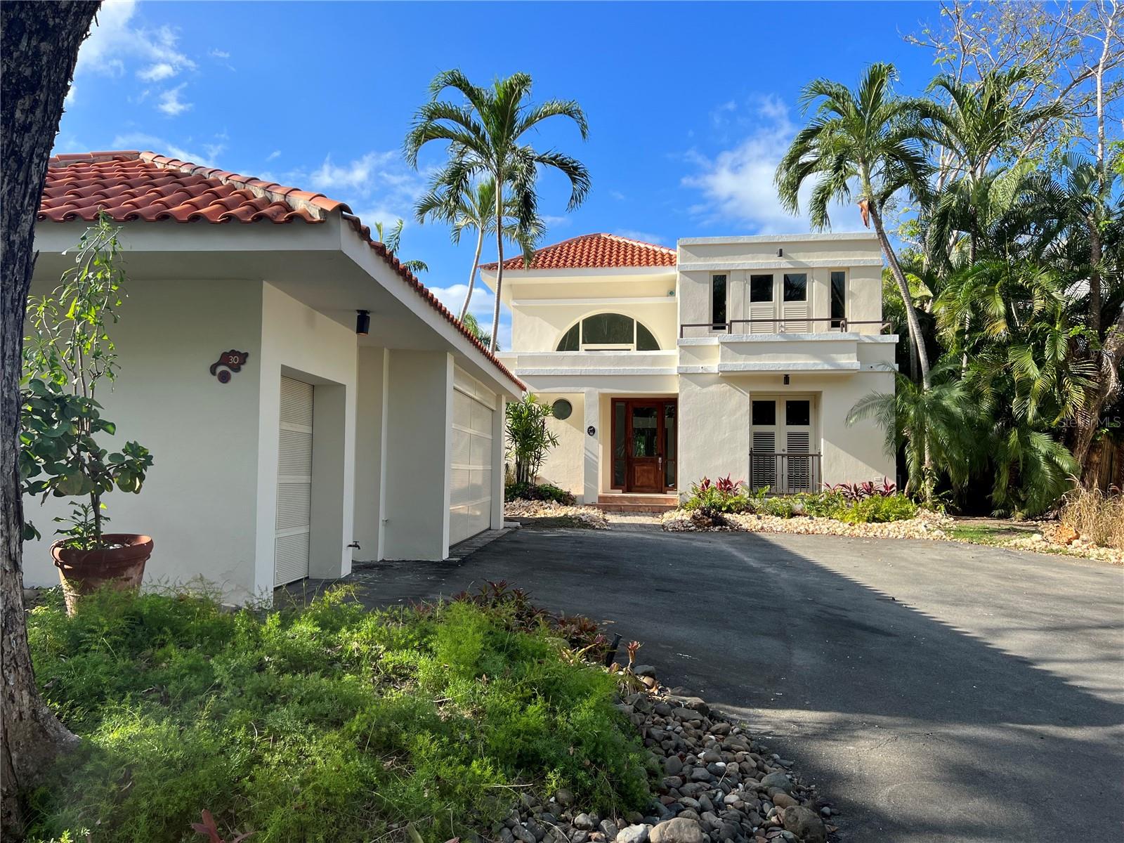 This exquisite house boasts unparalleled elegance and sophistication, featuring spacious living areas, open space layout, and breathtaking views of the surrounding lush landscape. With top-of-the-line amenities, including pools, tennis courts, and exclusive beach access, this property offers the ultimate in resort-style living. This home is convertible to 4 bedroom and is located in one of the best locations in the neighborhood with no neighbors on the back, private driveway, 2 car garage, 1 golf cart, 22k generator and water cistern. Remodel Plans, are available by request. Don't miss this rare opportunity to own a piece of paradise in one of the most sought-after neighborhoods in Dorado Beach.