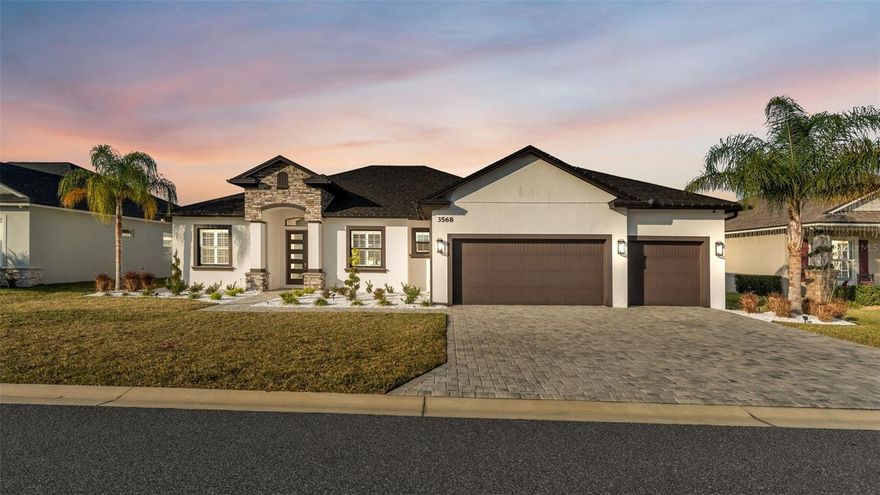 Welcome to this custom-built Tapia Homes residence located in the highly desirable Lakeside Heritage community. Thoughtfully designed and meticulously maintained, this 4-bedroom, 3-bath home with a screened saltwater pool offers an exceptional blend of luxury, comfort, and indoor-outdoor living.
From the moment you arrive, the home impresses with beautiful curb appeal, upgraded landscaping, and a paver driveway leading to a striking five-panel glass front door. Inside, the open-concept layout is filled with natural light and showcases wood-look tile flooring throughout the main living areas, soaring tray ceilings with stained wood beams, crown molding, and designer finishes.
The great room serves as the heart of the home, highlighted by a floor-to-ceiling stone electric fireplace flanked by custom-built-in shelving, adding both warmth and functionality. Expansive triple-panel sliding glass doors fully pocket to the exterior, seamlessly connecting the living space to the lanai and pool—perfect for entertaining or everyday Florida living.
The chef’s kitchen features granite countertops, a large center island with seating, farmhouse sink, stainless steel appliances, a coffee bar, ample cabinetry, and a walk-in pantry, all flowing effortlessly into the dining and living areas.
This desirable triple-split floor plan provides excellent privacy. The primary suite is a true retreat with tray ceilings, private lanai access, and a spa-inspired en-suite bath featuring a freestanding soaking tub, oversized walk-in shower, dual vanities with granite countertops, and a spacious walk-in closet. A second en-suite bedroom also offers direct pool access, ideal for guests or multi-generational living. Two additional bedrooms share a well-appointed guest bath, while a dedicated flex room with built-ins offers the perfect home office or study.
The well-designed laundry room includes custom cabinetry, a utility sink, and upgraded backsplash tile, adding both style and practicality.
Step outside to your private backyard oasis featuring a fully screened, pavered lanai and saltwater pool with sun shelf, ideal for relaxing, entertaining, or enjoying year-round outdoor living. The fully fenced yard provides added privacy and space.
Additional highlights include a pocketing sliding glass door to the lanai, a spacious three-car garage with ample storage, and quality craftsmanship throughout. Conveniently located just minutes from the Banana Lake boat ramp, shopping, dining, medical facilities, and the Polk Parkway for easy commuting.
This exceptional home offers luxury, flexibility, and lifestyle—no waiting to build, just move in and enjoy.