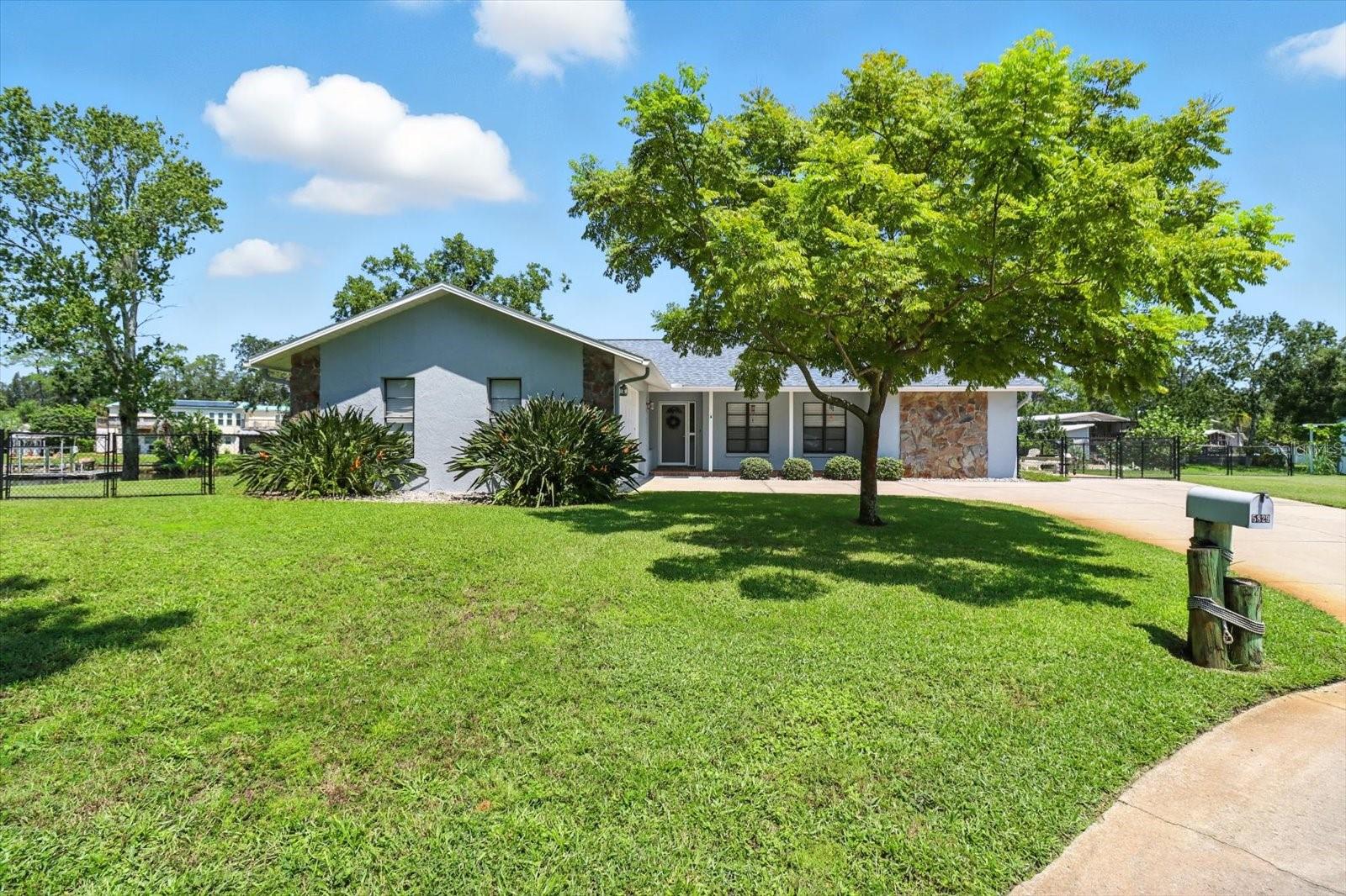 RIVERFRONT HOME ON THE MARKET FOR THE FIRST TIME IN OVER 25 YEARS! Nestled at the end of a quiet cul-de-sac, this charming 3-bedroom, 2-bathroom, 2-car garage home sits on an expansive .44-acre WATERFRONT lot and offers a rare chance to enjoy true Old Florida living, with NO HOA to restrict your lifestyle. NEVER FLOODED or come close!
Enjoy a front-row seat to daily visits from dolphins and manatees, right from your backyard on the beautiful Anclote River, flowing directly behind the home. To the side of the home, a serene spring-fed pond adds even more natural beauty and feeds into the river, creating a peaceful, one-of-a-kind setting.
Step inside to the living room filled with natural light and multi-sliding doors that lead out to a generous screened-in porch, offering water views and a gentle evening breeze.
The eat-in kitchen features stainless steel appliances, stylish reeded cabinets, a large pull-out pantry, RODI water system, gorgeous granite countertops and even more access to the screened porch through sliding glass doors.
The spacious master suite includes a walk-in closet, linen closet, and sliding doors with a view of the river, while the en-suite bath offers a bright, cozy feel with a walk-in shower. Two additional bedrooms provide ample space and large closets.
Additional highlights include:
NEW ROOF (2024)
A/C (2016)
Utility sink in the garage
Detached storage shed
Kayak Launch
Flexible laundry room that can be used as an office, with washer/dryer hookups in the garage.
Don't miss your chance to own this rare slice of paradise, schedule your showing today!