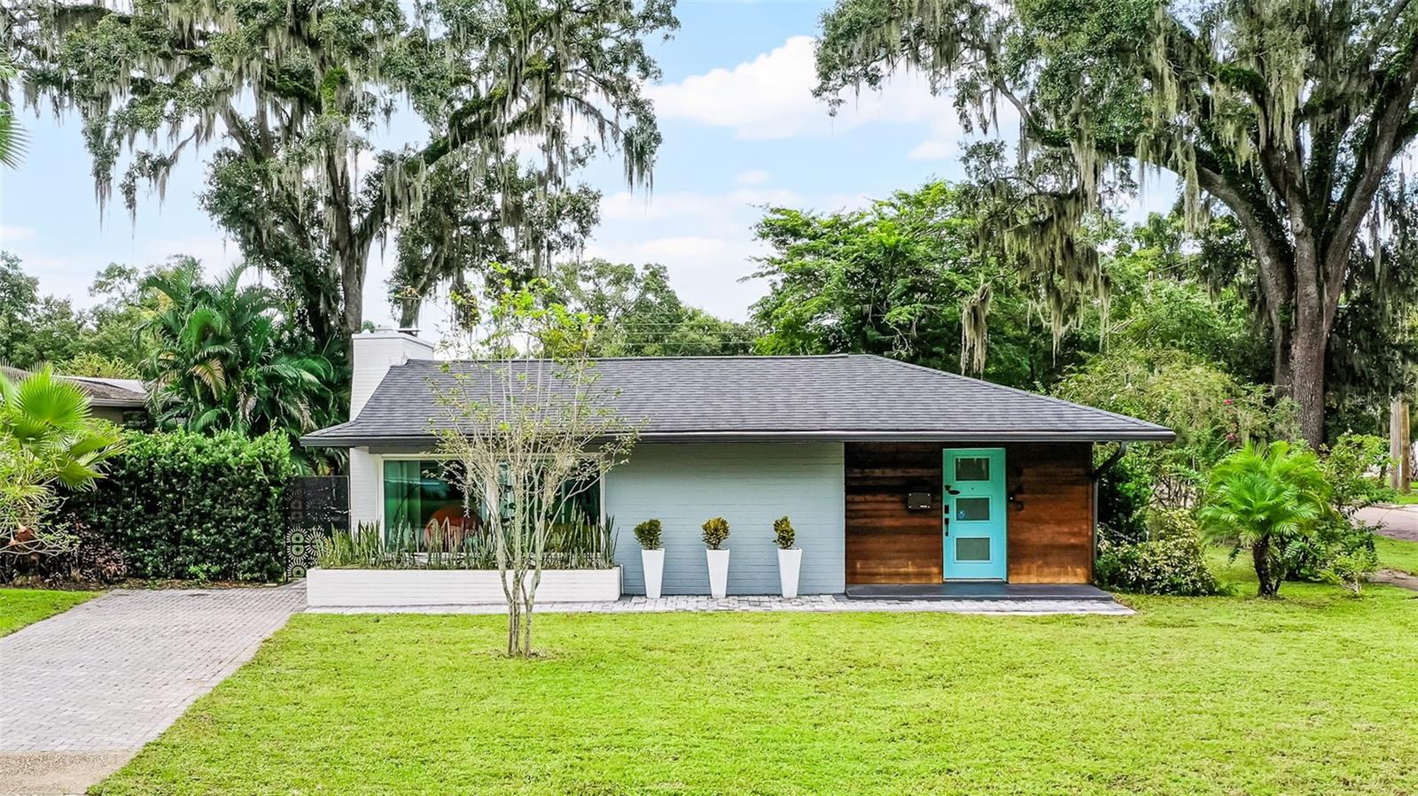 Imagine coming home everyday to this timeless mid-century masterpiece and calling it your own...well now you can. 940 Alba Drive, located on a picturesque tree-lined street in one of Orlando's most sought after neighborhoods of College Park, can now be yours. Conveniently positioned on the corner of Alba and Westmoreland with not one, but two driveways, this combination of simple architectural lines and mature landscaping equal the perfect blend of sophistication and modern construction. Once you're past the pavered driveway and across the threshold, you are immediately immersed within the stunning updates that are seen from every corner, beginning with new white oak flooring, quartz countertops, 42" cabinets and complemented by GE Cafe appliances. An oversized living room with wood burning fireplace is adjacent to a dedicated dining space, and all surrounded by colossal sized windows and sliding glass doors, that allow natural light to beam in from every corner from the moment once the sun rises. Your primary bedroom has direct access to the central courtyard with large sliding doors, as well as walk-in closet, and well updated en-suite bathroom; with floor to ceiling tile. A second bedroom has it's own en-suite bathroom, and would be perfect for a younger adult, out of town guests, or even a multi-generational family. Two additional bedrooms are located down the hallway, each of them with their own closets, and access to yet another well-updated full bathroom, making this the full 3rd bathroom of the home. 5 ¼'" baseboards line the hallways and common areas, while recessed lighting in every room sets the stage for when the sunsets. If you like to entertain and be the "go-to" for holidays and family get-togethers, you'll be the new envy of your circle. A substantial sized central courtyard is the focal point of the backyard, which can be seen from multiple areas of the inside of the home, and would be the quintessential backdrop to any of those events, and just imagine enjoying one of your morning cappuccinos or evening cabernets with the tea lights on....does it get any better? Step up your hosting skills and you can even "don your chefs hat" while making pizza in your own original outdoor oven. NO HOA | ZERO CARPET | AT&T FIBER CONNECTED | WATER FILTRATION SYSTEM | NEWER HVAC & WATER HEATER | LEAF FILTERS ON GUTTERS | EV CHARGER IN GARAGE | BUILT-IN CLOSET IN PRIMARY BEDROOM | ALL NEW DUCTWORK | Don't you deserve to walk into a home like this every day?