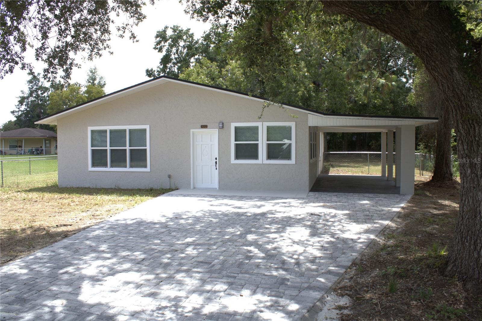 Unlock the potential at 9312 Bahia Rd—a move-in-ready starter home or exceptional investment in Ocala’s growing Silver Springs Shores. This fully renovated 1,536 sq ft. home, with a master suite and two generously sized secondary bedrooms, 2-bath. Features a brand-new roof, fresh interior and exterior paint, updated electrical, new A/C, ALL windows in home have been replaced with energy-efficient windows, and luxury vinyl plank flooring throughout the entire home. Outside paver walkways add charm and functionality, while the spacious 0.37-acre, blank canvas fenced-in lot offers privacy and ample room to enjoy Florida's outdoor living. Inside, you’ll find a stylish, modern kitchen with QUARTZ countertops, soft-close white shaker cabinets, and brand-new stainless-steel appliances. Both bathrooms have been beautifully updated with modern finishes, making this home both functional and attractive. Located in a no-HOA neighborhood, this home combines comfort with convenience. You’re just minutes from grocery stores, dining options, medical facilities, trail access, and local community amenities. Golf courses, parks, and downtown Ocala’s vibrant arts and culture scene are also close by. LA is co-owner. Don’t miss your chance to own a piece of Ocala’s bright future!