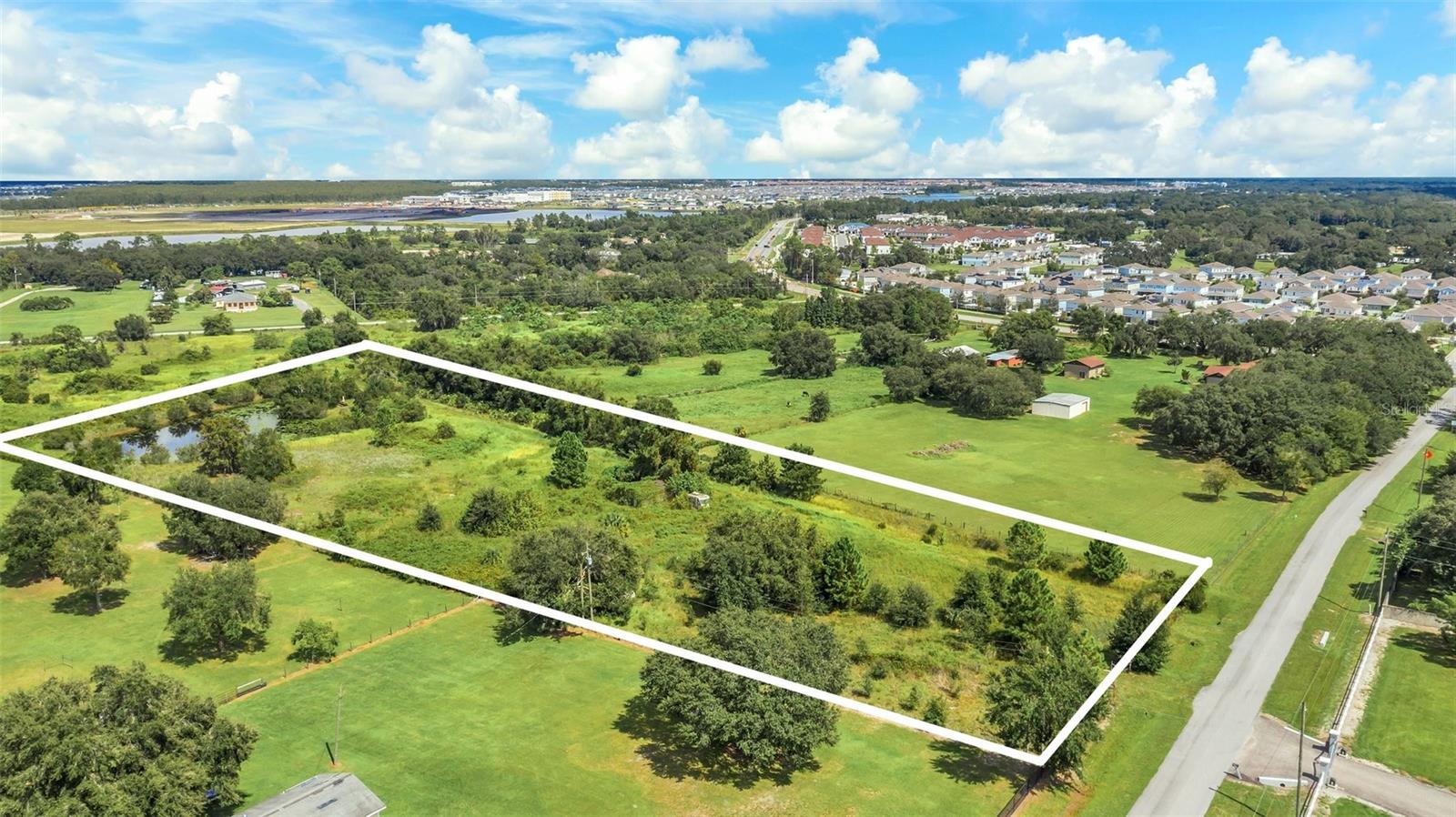 Seize this rare chance to invest in a promising 5-acre parcel strategically located in Kissimmee's rapidly growing corridor. This property presents an exceptional opportunity for savvy investors and developers looking to capitalize on Osceola County's expanding business landscape. Currently zoned as OAC (Open Agriculture and Conservation), the Future Land Use (FLU) is in the process of changing to Industrial, pending county and state finalization. This transition opens doors to a wide array of development possibilities, from manufacturing facilities and warehouses to logistics hubs and research complexes. The property's strategic location near Orlando International Airport, major highways, Lake Nona Medical City, and Kissimmee's booming tourism sector positions it perfectly for future industrial growth. With no HOA restrictions and an existing pond on site, this parcel offers flexibility for creative site planning. Public water and electricity are available, further enhancing its development potential. Whether you're looking to develop immediately upon FLU finalization or land bank for future appreciation, 4281 Timber Lane offers a unique entry point into Kissimmee's burgeoning industrial market. Don't miss this opportunity to be part of Osceola County's dynamic growth and position yourself at the forefront of Kissimmee's industrial expansion. Schedule your site visit today and take the first step towards securing this promising investment in Central Florida's future.