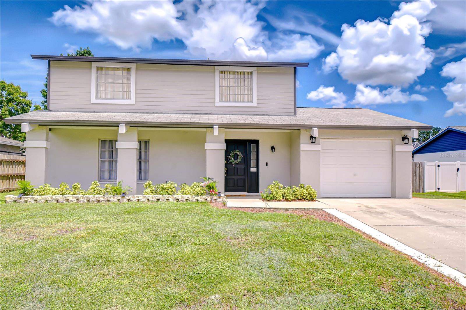 Stylish, move-in ready, and loaded with charm—this beautifully upgraded 4-bedroom, 2.5-bath home offers the ideal blend of comfort and function in the highly desirable Logan Gate Village community, perfectly located bordering Carrollwood and Citrus Park. With over 1,700 square feet of living space on a lush 70x100 lot, this home shines with curb appeal and thoughtful updates throughout—and best of all, there's NO HOA and NO CDD to limit your lifestyle. From the moment you arrive, you'll be struck by the home's crisp, clean appearance and manicured green lawn. Fresh landscaping, vibrant mulch beds, and classic curb details—including a welcoming front porch with contrast-banded columns, coach lights, and a stately front door flanked by sidelights—set the tone. The 2023 exterior paint still looks like new, and a 2021 roof adds peace of mind for years to come. Step inside to a spacious and updated interior where wide plank wood-tone laminate flooring flows through the living areas and kitchen, creating warmth and continuity. Carpet, installed in 2023, adds cozy comfort to the bedrooms and upstairs den. The open living and dining areas offers flexibility for entertaining and family time, while large windows bring in abundant natural light. The kitchen, fully remodeled in 2023, is both beautiful and functional—featuring solid wood Shaker cabinets with stainless pulls, sparkling Quartz countertops, a striking glass subway tile backsplash, and a full suite of stainless steel appliances, including a double-door refrigerator, range, microwave, dishwasher, and a deep undermount sink. Just off the kitchen, the sunny eat-in breakfast area includes a convenient storage closet and opens to the screened lanai through elegant French doors. Out back, enjoy your fully fenced yard—ideal for outdoor dining, gardening, or letting pets play freely. The screened lanai with outdoor carpeting is a comfortable extension of the living space and perfect for quiet mornings or casual gatherings. Upstairs, a double-door den offers the perfect bonus space for a home office, playroom, or media lounge. The serene primary suite features a generous closet and a private ensuite bath with Quartz-topped vanity, undermount sink, and a sleek walk-in shower with glass barn-style door. Three additional bedrooms provide space for guests, kids, or hobbies, and the hall bathroom includes a tiled tub/shower combo with matching Quartz vanity. Additional 2023 upgrades include stylish light fixtures, ceiling fans, updated mirrors, and fresh interior paint in a versatile neutral palette. The attached 1-car garage with coach lights adds convenience and charm, and the home sits on a generous 0.16-acre lot offering room to grow and play. Logan Gate Village offers a wonderful sense of community and features a scenic pond and playground right at the entrance—perfect for families, joggers, and anyone who enjoys the outdoors. The location is unbeatable, with easy access to top-rated schools, Citrus Park Mall, the Upper Tampa Bay Trail, Veterans Expressway, Tampa International Airport, Raymond James Stadium, and a wide variety of restaurants and retail. Plus, the Gulf beaches are just a short drive away, making weekend escapes a breeze. If you’re seeking a home with tasteful upgrades, great space, and an unbeatable location—this one checks every box. Don’t miss the opportunity to make it yours. Schedule your private tour today!