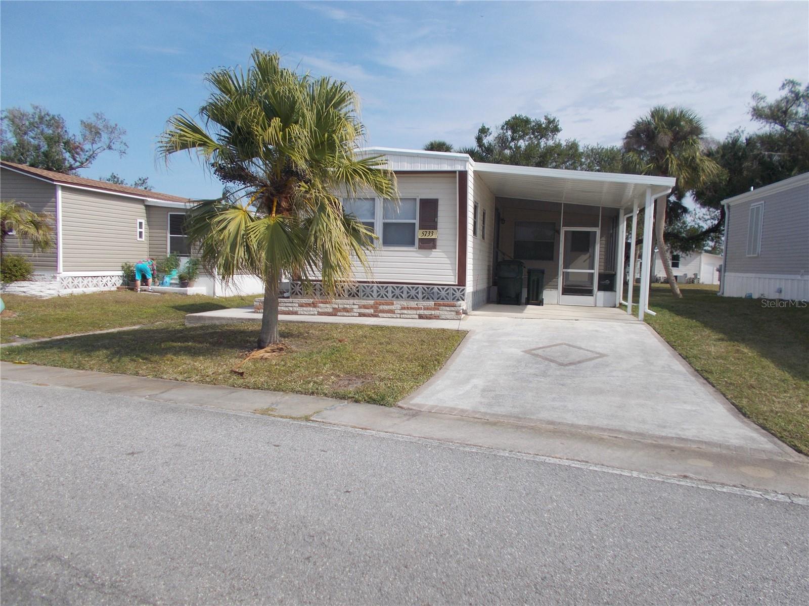 This is a 2 bedroom, 2 bath furnished home in the PET SECTION, in the gated mobile home community of Holiday Park. Your Living Room is in the front of the house and you have an eat-in Kitchen with a gas stove. You can access the Lanai from the sliding glass doors off of the Kitchen. Your bedrooms are in the back of the house with the Washer/Dryer in the closet in Bedroom #2. Both bathrooms have showers. As per owner, new AC in 2024, Electric Panel 2022, new carport and Amerigas in 2018. In Holiday Park you own the land with a deed and your monthly maintenance charge of $195.00 ($2340.00 a year) is included in your taxes. This community features 2 clubhouses, 2 swimming pools, a library, a fitness room, tennis courts, pickleball and Bocce to name a few. You are close to dining, entertainment, numerous golf courses, sport facilities and SW Florida's renowned beaches. Come take a look!