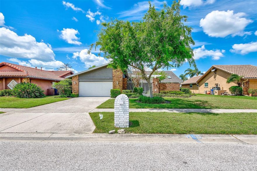 Welcome to this beautiful lakefront pool home offering space, privacy, and stunning views of Lake Seminole. From the moment you arrive, the gated front entrance and mature landscaping create a welcoming and private approach to the home. This well-maintained 3 bedroom, 2½ bath home with an office/flex room and oversized two-car garage sits on over a ¼ acre with a private dock, making it the perfect Florida retreat.

Inside, the open floor plan is designed for both everyday living and entertaining, featuring vaulted ceilings throughout most of the home that enhance the sense of space and natural light. The pass-through, open kitchen features white cabinetry, quartz countertops with a breakfast bar, stainless steel appliances, and skylights that fill the space with natural light. The kitchen overlooks the spacious living room with a fireplace and expansive views of the lake through fully opened hurricane-rated sliders. The dining area is conveniently located just off the kitchen, creating a natural flow for everyday meals and entertaining. On the opposite side of the kitchen, you’ll find a hidden pantry and coat closet, along with access to the large utility room featuring a washer, dryer, sink, and additional storage, which leads into the oversized two-car garage with epoxy flooring and extra storage space.

The large primary en-suite is a private retreat featuring a slider to the pool overlooking the lake. Dual closets provide a walkway to the primary bathroom, which includes a separate standing shower, Jacuzzi tub, dual vanities, and a skylight that brings in beautiful natural light along with a picturesque view of the front garden. The split floor plan offers privacy, with the primary suite and office/flex room with convenient half bath access on one side of the home.

On the opposite side of the home, the second and third bedrooms are both spacious and bright with generous closet space. One of the guest bedrooms features a beautiful lake view, providing a peaceful setting for guests or family members. The guest bathroom includes a walk-in shower and large vanity and is conveniently located between the two bedrooms.

Outdoor living is just as impressive, featuring a large enclosed patio with a covered area overlooking the pool and lake — perfect for relaxing or entertaining year-round. The large lot, mature landscaping, pool, and private dock create a true waterfront lifestyle with beautiful sunset views over the lake.

Additional features include hurricane windows and sliders, a 2021 roof, fresh interior paint, engineered wood flooring throughout, shutters and blinds, skylights in the kitchen and primary bathroom, and plenty of storage throughout the home.

The decorating and furniture are also negotiable, offering a move-in ready opportunity for buyers looking for a beautifully styled waterfront home.

This home is situated in a desirable area near Lake Seminole Park, Gulf beaches, shopping, dining, and top-rated schools, offering the perfect balance of quiet waterfront living with convenient access to everything the Largo and Seminole area has to offer.