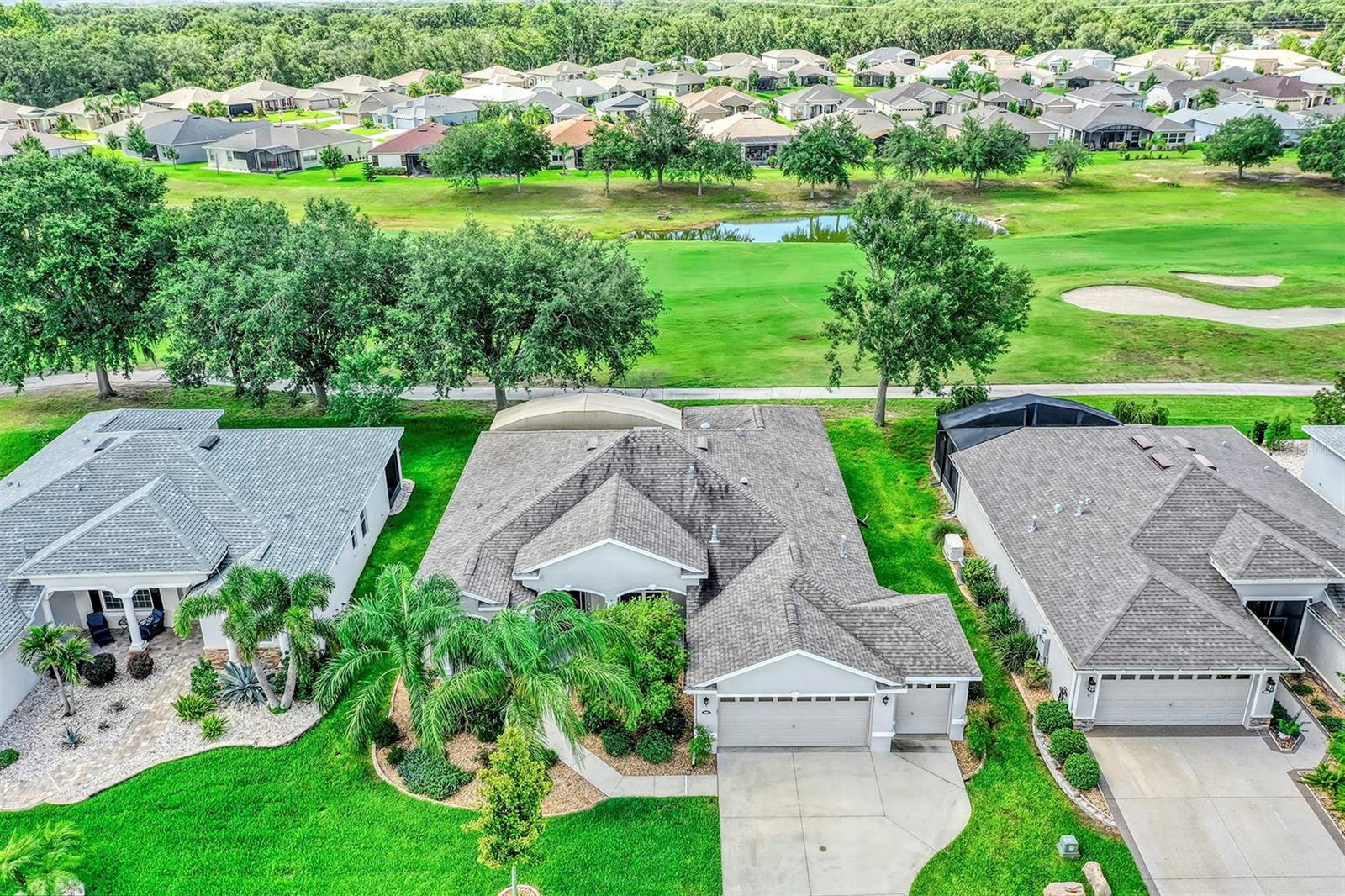 PRICED TO SELL! Golf-Front, Modern, Affordable Low-Maintenance Stucco Home built in 2018 Located in Guard-Gated Golf & Active-Adult Community, 2,236 square foot Open Floor Plan, 3 Bedroom 2 bath, OVER-SIZED 2 car garage plus golf-cart garage w/ epoxy floor, all appliances including washer, dryer & Water treatment system stay with home. Indoor laundry room with utility sink & cabinets Located in Highly sought after Arlington Ridge only 3 minutes from amenities, restaurant & Pub. Discover a lifestyle of comfort and leisure you've waited for your whole life for, Very Low HOA of $125 per month includes, mowing, trimming & blowing of lawn allowing you more time to enjoy your retirement and Wi-Fi router for signal coverage throughout the home, 200+ cable TV channels, and 250-megabyte high-speed internet are also included in the super-low HOA. Two DVRs are also included for recording your favorite shows which is all included HOA, Community has sidewalks and underground utilities for more luxurious look & feel. 17x16 Living room with vaulted ceiling is great for entertaining Kitchen features 4 seat bar-top island, pantry, abundant wood cabinets & quartz counter-tops & natural gas range and fridge that stay. The master bedroom features an en-suite bath with comfort height vanity, a walk-in shower, for added safety and walk-in closet . Split Plan for guest bedroom provides ultimate privacy. Massive golf-front covered & screened lanai with plenty of shade and a separate slab for grilling out. In the rare case you need it, the home is equipped with a natural gas powered whole house generator that is reliable and never needs filling. Home is located in low wind zone being in the center of the state. Benefit from huge discounts on homeowner's insurance due to the home's high construction standards being built to wind code, high & dry elevation for flood protection, and a low wind zone, also qualifying for additional insurance discounts. The low HOA of $124/month makes this community even more affordable than nearby communities This coveted community offers a wide range of amenities, including an 18-hole golf course where you can get a tee time year round, driving range, putting greens, YOU DO NOT HAVE TO PURCHASE A SOCIAL OR GOLF MEMBERSHIP TO LIVE IN COMMUNITY OR PLAY GOLF, lighted tennis and pickleball courts, heated swimming pools, hot tub, fitness facilities, billiards, a restaurant, tavern, and a free movie theater. The community is golf cart-friendly, with sidewalks for strolls and low-speed limit streets perfect for bicycling. Enjoy the convenience to grocery stores, restaurants, banks, pharmacies, free dog parks, hiking trails and completely shaded playground within a 5-minute drive. Emergency services are just 10 minutes away, and a free boat ramp and fishing pier on a 15,000-acre lake are nearby. Community is 20 minutes from malls, restaurants, and a 12-screen movie theater, 45 minutes from Orlando, Major theme parks, and the airport, 90 minutes to Daytona Beach & Atlantic Ocean and Gulf of Mexico Clearwater. PROPERTY IS NOT HOMESTEADED, PROPERTY TAX IS LOWER WHEN YOU LIVE IN HOME YEAR-ROUND, SJS 2025©