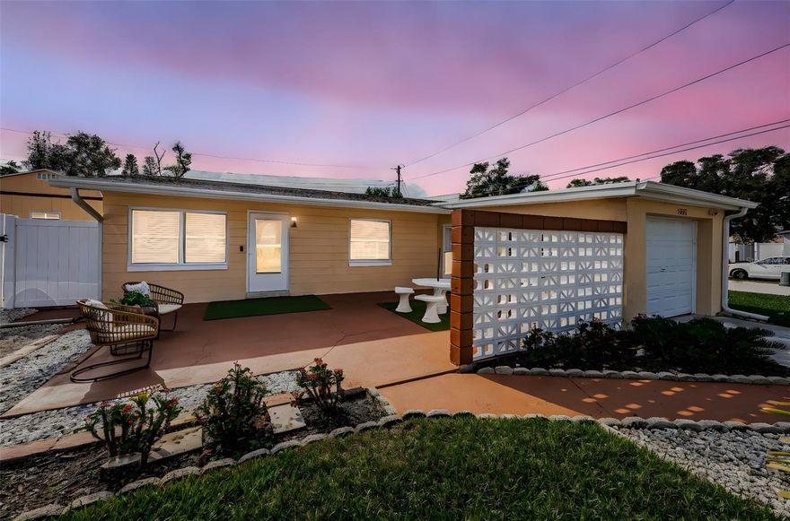 Renovated Home with Numerous Upgrades. This meticulously maintained home has undergone a major renovation, making it a true gem, located walking distance from parks, schools and the Pinellas Park Arts District as well as the nearby England Brothers Park featuring numerous concerts and events. A hurricane-standard roof was installed in March 2023, New Electrical Panel 2023, and a new AC system was installed in 2021, complete with UV filtration to ensure fresh and clean air throughout the home. Additionally, new AC ducting was installed in April 2023, optimizing the efficiency and airflow of the cooling system.  Inside, the house features new flooring, a fully upgraded kitchen, and modernized bathrooms. The kitchen is equipped with all stainless steel appliances, and showcases elegant quartz countertops. The home's interior is light-filled and spacious, with versatile multi-use spaces that provide endless possibilities for customization. In addition to the living room and dining area, a large den offers a flex space for all of your activities and hobbies. Full size stacked brand-new Samsung washer and dryer are located in the spacious laundry room. The exterior of the property boasts a new vinyl fence, installed in April 2023, which encloses a spacious yard adorned with a 1-year old Swim Spa, a delightful gazebo, situated on a concrete pad, offering a peaceful retreat. Brand new gutters with leaf guards ensure low maintenance. Florida Shed with hurricane tie downs and a loft installed in 2024. Throughout the home you'll find charming wood accents, including a barn door, accent barnwood shelving, and a solid wood front door, adding a touch of rustic elegance. Large master suite with sitting area and TONS of closets. High end master bath with dual sinks,  luxury shower and lighted mirrors. The front of the property boasts an enormous patio with privacy walls, creating a private outdoor space for entertaining or relaxation. The one-car garage is equipped with an opener and has AC ducting, allowing for multiple uses beyond just parking. This well-located, renovated home on a large lot presents a wonderful opportunity to own a property that combines modern upgrades with appealing features, creating a comfortable and inviting living environment. Have an RV or a boat? No problem. Place to park it is ready for you, in addition to extra parking beside expanded driveway. Come see how this could be the perfect fit for you and your toys or hobbies. Does not require flood insurance and in Evacuation Zone D.