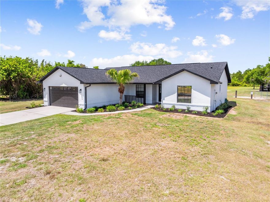 Welcome to your private slice of country living with modern convenience. Situated on 2.3(+/-) beautifully maintained acres this 3 bedroom 2 bathroom home was custom built by the locally well known reputable builder Danny Quinn and showcases quality craftmanship throughout. Inside you'll find a completely remodeled kitchen featuring tasteful shaker style cabinetry, elegant quartz countertops and a clean modern design that flows seamlessly into the living space. There is a dinette area for a breakfast table and separate dining room with stunning chandelier.  Durable wood look tile runs throughout the home offering both style and easy maintenance. Home has fresh interior and exterior paint, in wall pest control system and a 2 year old roof adding peace of mind for years to come.  Step outside and enjoy everything this property has to offer. Equestrian enthusiasts will love the 2 stall horse barn complete with stall fans, concrete floors, electricity, water and a separate feed/tack room with an upstairs hay loft. The property is fully fenced with the pasture thoughtfully separated from the home making it ideal for animals while maintaining a private residential setting. A new well pump house adds additional functionality and value. Relax on the screened in back patio and take in the peaceful surroundings perfect for quiet mornings with coffee while watching deer and wild turkey roam around the back pasture. All of this is conveniently located near shopping, schools, restaurants, area lakes, the Florida Turnpike and Lake Nona offerinf the perfect balance of country living and city access.