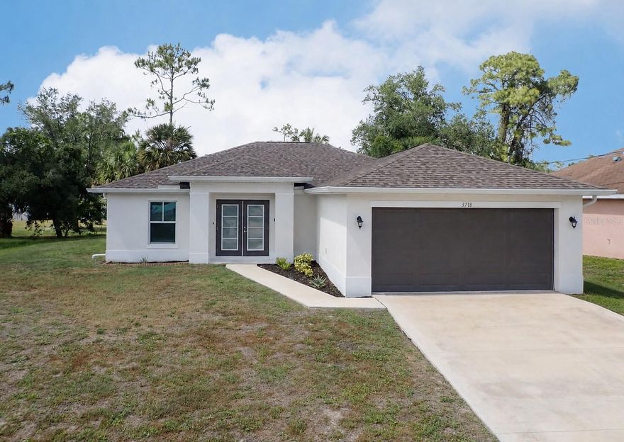 One or more photo(s) has been virtually staged. PLEASE SEE THE 3D INTERACTIVE TOUR!  Better than new and built in 2023, this stunning 4-bedroom, 2-bathroom home with a 2-car garage offers modern design, quality finishes, and peace of mind in one of Southwest Florida's fastest-growing communities. Featuring a desirable open-concept floor plan, this home is highlighted by luxury vinyl plank flooring throughout, creating a seamless and low-maintenance living space. The spacious kitchen is designed to impress with elegant quartz countertops, stylish shaker-style cabinetry, stainless steel appliances, and ample counter space—perfect for both everyday living and entertaining. The split-bedroom layout provides privacy for the owner's suite, while three additional bedrooms offer flexibility for family, guests, or a home office. Built with impact-resistant windows, this home provides added storm protection, energy efficiency, and security. Conveniently located in North Port, you'll enjoy easy access to shopping, dining, schools, parks, and the beautiful Gulf Coast beaches and Wellen Park.