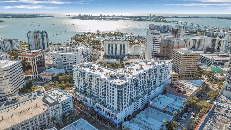 Penthouse level at The Mark Sarasota, complete cosmetic renovation by current owners. Enjoy views of Sarasota Bay and downtown Sarasota. This west- facing residence encompassing 2,485 square feet under air, 342 square feet of terrace space, totaling 2,827 square feet, the thoughtfully designed floor plan includes three ensuite bedrooms plus a den/office, three-full baths, and one-half bath with a desirable split-bedroom plan that features a primary suite wing. Timeless in design, the gourmet kitchen is beautifully appointed with Nolte European cabinetry, JennAir stainless steel appliances, an upgraded induction range, new quartz countertops with 6 cm waterfall island, new modern tile backsplash— perfect for entertaining. The open-concept living and dining areas are highlighted by soaring 11-foot ceilings, floor-to-ceiling glass, and large format porcelain tile flooring, creating a bright and architecturally refined interior. An expansive west-facing terrace extends the living space outdoors and features a built-in grill and beverage refrigerator, ideal for sunset dining and indoor-outdoor living. The primary suite offers a luxurious retreat with two spacious walk-in closets and a spa-inspired bath featuring an oversized double vanity, quartz countertops, a large walk-in shower, and a separate soaking tub. Two guest ensuites each include generous closets, while the den off the foyer serves as a perfect home office. New Legno European white oak oil-waxed floors in all bedrooms. A large laundry room with utility sink and new custom cabinetry adds convenience and storage. Additional highlights include abundant natural light, a new smart Lutron system controlling lighting and shades throughout, and a new custom wet bar with Sub-Zero beverage drawers and Scotsman ice maker. This residence delivers an elevated expression of luxury condominium living in the heart of downtown Sarasota. Enjoy westerly views of the tropical pool deck and glowing Sarasota Bay sunsets. Two deeded parking spaces, one with EV charging. A generous climate-controlled storage unit in a secure room, where packages are safely held, adds exceptional convenience only steps down the hall. The fifth-floor amenity level offers resort-style, heated saltwater, edgeless pool, spa, fire-pit, lounge, grilling pavilion, bar, club room with catering kitchen, billiards, newsroom, and a premier fitness center with yoga and spin studio. At your doorstep, experience the best of downtown Sarasota, from fine dining at Hyde Park Steakhouse, Saturday Farmer’s Market, and Boca or Besos for tapas. Explore nearby luxury car dealership, galleries, salons, and many conveniences. Cultural treasures such as the Sarasota Opera House, Florida Studio Theatre, and Sarasota Art Museum are walking distance, while boaters will enjoy Marina Jack. Lido Beach is over the Ringling Bridge. With 24-hour concierge service, secure access, on-site management and a pet-friendly atmosphere, effortless grandeur unites luxury, convenience and Sarasota’s signature coastal charm in one unforgettable downtown address.