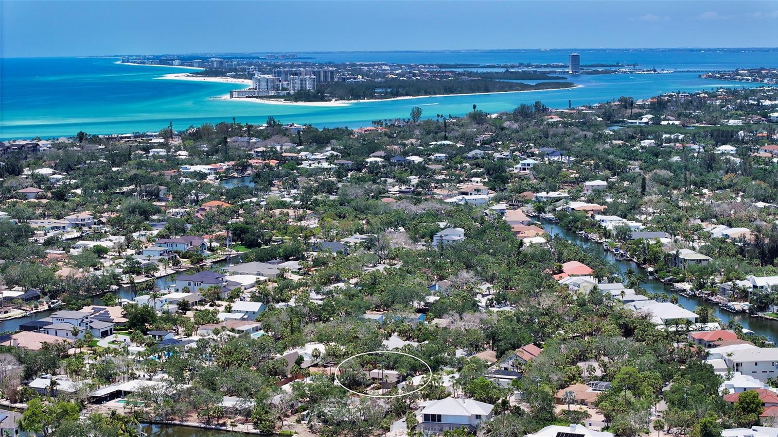 One or more photo(s) has been virtually staged. Nestled in a tropical setting, this charming newly updated 3-bedroom 2-bath "beach retreat" located one mile from Siesta Key ‘s #1 ranked beach internationally …checks all the boxes! New roof, new doors & hurricane impact windows – check! Upon entering a fresh, airy feeling is welcoming. From the ceramic-tiled living room your eye travels beyond the den area to the tropical outside setting, fully fenced private and secure. The kitchen is quality with all stainless appliances, quartz counters and light cabinetry. A separate dining area has easy access to the outdoor deck. Primary bedroom with new en-suite bath and luxury wood vinyl floors is located for privacy from the 2 guest suites with same type floors and bath blending whites and beige palette with marble counter tops and tile floors. A spacious laundry room with washer and dryer opens to the single car garage. Indigenous plantings and a circular paver brick drive and walkway add to charm and curb appeal. Located in a great family neighborhood and nearby Out-of-Door Academy. Ready for immediate occupancy this is an ideal choice for a winter retreat or an investment with unlimited rental possibilities.