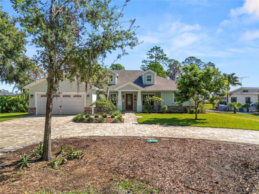 Welcome to this stunning 4 bedroom, 3 bathroom, lake front home with NO HOA, sitting on almost a full acre of land in a quiet community with easy access to shopping, dining, and major roadways! The roof was replaced in 2023 and the 2 AC units were replaced in 2020. The home features 2 Rinnai gas water heaters with an on demand system. Additionally, the home offers a Kohler gas propane tank/generator automatic transfer system to power the entire home during a power outage. Arriving at the home, you’ll appreciate the beautiful landscaping and paver circular drive and driveway, and cozy front porch, the perfect spot for sipping your morning coffee. Entering the home, you’ll find luxury vinyl flooring throughout the home and a real pine wood accent wall. The home features a formal living and dining area with tray ceiling and updated lighting. The beautiful kitchen offers 42 inch cabinets, quartz countertops, stainless steel appliances, retractable soft close drawers, custom pantry, glass tile backsplash, and a gas stove. The family room located at the back of the home features a wet bar with sink and cabinets, a wall plug for a small refrigerator, a ceiling fan, and 8 ft. double doors for privacy. The large primary suite has tray ceilings, updated lighting and plenty of natural light. The en-suite bathroom provides a dual sink quartz top vanity with extra storage space, huge walk-in shower, a private water closet and two custom walk-in closets! The remaining 3 bedrooms have 9.5 ft. ceilings and updated lighting. The main hall bathroom features a large quartz top vanity with storage space and a tub/shower combo with tile surround. The 3rd bathroom features a single sink vanity and stand up shower and provides access to your patio. The home also features an indoor laundry room with gas dryer hook up, storage cabinets, a sink, and a storage closet. Stepping out onto your large screened in patio, you’ll love the view of the mature palm trees throughout the back yard. Additionally, there is a large paver patio and a new 11 X 20 storage shed. Some additional features of the home include an epoxy coated garage floor, a gutter system with downspouts, and a well water chlorination treatment system. This home has so much to offer, schedule your private showing today!