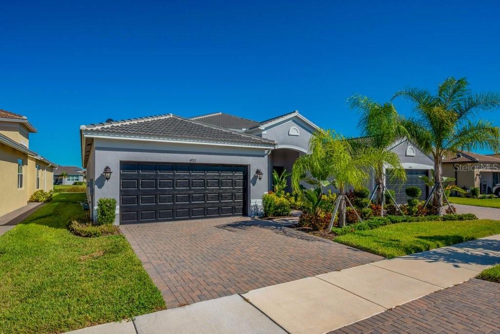 Located in Valencia del Sol, the most exciting  55+ resort-style community on Florida’s Gulf Coast, this beautifully partially furnished and decorated Columbia model offers a perfect blend of luxury, comfort, and carefree living. Designed with an open great-room layout, this home features 2 bedrooms, a den/3rd bedroom, 2 baths, and a 2-car garage, making it ideal for both relaxation and entertaining.
The gourmet kitchen opens seamlessly to the dining area and spacious great room, flowing directly to the covered and screened lanai through triple 8-foot glass sliders that frame a stunning water view. Inside, you’ll find elegant 18x18 tile flooring laid in a waterfall offset pattern throughout the main living areas and den. The kitchen is a showstopper, boasting 42” Dove Maple cabinetry with crown molding and valance, soft-close dovetail drawers, under and over cabinet lighting, Silestone quartz countertops, a designer mosaic backsplash, and a counter-height extended bar top. Premium GE stainless steel appliances include a gas range, French door refrigerator, microwave, and built-in pantry.
The spacious master suite features a coffered ceiling and two large walk-in closets, while the luxurious master bath includes a walk-in shower with decorative tile to the ceiling, quartz countertops, and comfort-height Dove cabinetry. The second bedroom also offers a walk-in closet, and the den/3rd bedroom features elegant double French doors. The laundry room is complete with upper cabinets and GE washer and gas dryer.
Loaded with upgrades and set in a vibrant, active community that offers resort-style amenities, endless activities, and a friendly neighborhood atmosphere, this exceptional home redefines 55+ luxury living in Tampa Bay.
