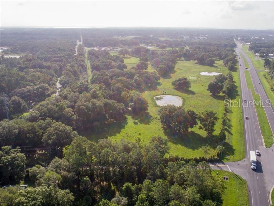 Here’s an opportunity to secure approximately 33 acres of prime land along one of Central Florida’s fastest-growing corridors! Comprising six parcels with an impressive ±1,426 feet of frontage on State Road 44, this property enjoys exceptional visibility just minutes from The Villages. An additional ±7-acre parcel (MLS #: G5053829) is also available, offering even greater potential for development. Currently zoned Agricultural, the property is ideal for future development. Annexation into the City of Leesburg, along with zoning and land use changes, would be required to fully realize its potential. Surrounding properties are zoned Industrial, and the Future Land Use designation of Urban Low Density provides flexibility for a variety of uses. The location is a standout—just five minutes from The Villages and Lake Deaton Plaza, featuring Publix, Walgreens, and the newly opened Hooters. A new Walmart Supercenter is nearing completion, enhancing the area’s commercial appeal. Downtown Leesburg is 10 minutes away, with easy access to US Hwy 27 and the Florida Turnpike to the west, placing Orlando just an hour away and Tampa within 90 minutes. Whether you're planning to develop, invest, or hold, this property offers strategic positioning in a thriving market with strong commercial and residential demand. Contact us today to explore the possibilities.