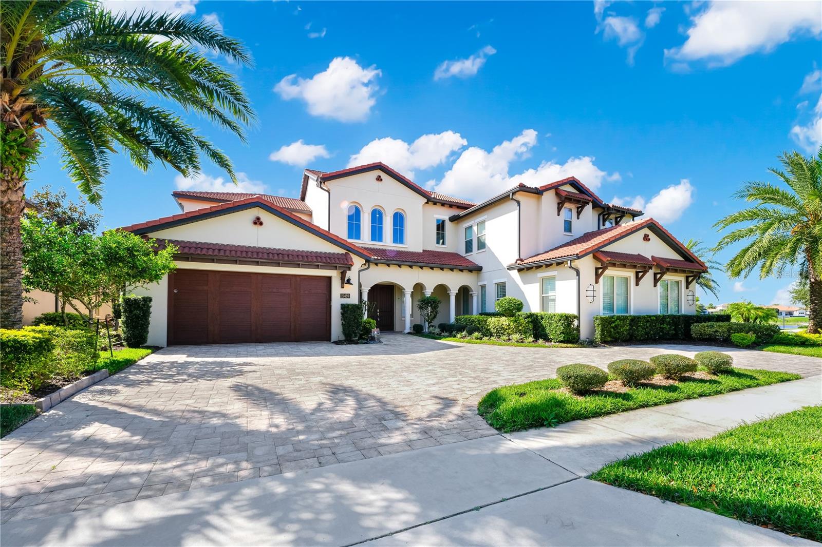Sellers provide 1% to buyer as closing assistance/ credit.
Luxury Lakefront Living at Its Finest
Breathtaking Views & Prime Location
Discover the pinnacle of elegance and comfort in this stunning lakefront model home, perfectly positioned on an oversized corner lot (0.54 Acres) with unparalleled views of the Lake and the Orange County National Golf Course in the front of the property.
Seamless Indoor-Outdoor Living
Step through the grand two-story foyer and be drawn to the massive pocket sliding doors that open to an expansive covered patio and pool deck—perfect for entertaining or unwinding. Take in breathtaking sunsets over the infinity-edge pool and spa while preparing meals in the fully equipped outdoor kitchen with a motorized screen. Or head upstairs to the covered balcony (a motorized screen )
for equally spectacular views. A state-of-the-art pest misting system ensures outdoor comfort all year long.
Chef’s Dream Kitchen & Elegant Living Spaces
At the heart of this home is a gourmet kitchen boasting a massive quartz island, coffee and wine bar, six-burner gas stove, and upgraded appliances. Custom cabinetry, featuring elegant glass doors, provides ample storage and display space. The open-concept design seamlessly connects the kitchen to the sophisticated dining and living areas, enhanced by exquisite ceiling details and premium fixtures.
Owner’s Suite – A Private Retreat
Escape to the luxurious Owners' Suite, bathed in natural light from large windows and featuring dual walk-in closets with premium wooden shelving. The spa-inspired en-suite bathroom boasts an oversized walk-in shower and freestanding soaking tub, delivering the ultimate relaxation experience.
Spacious In-Law Suite & Private Office
For added convenience, a separate in-law suite on the main level features a private living area, a spacious bedroom with a walk-in closet, and a full bath—perfect for guests or multigenerational living. A private office with French doors opens to the back patio, offering a serene workspace.
Second Floor – Bedrooms, Entertainment & More
Ascend the striking wooden staircase with modern railings to find four oversized bedrooms, three additional full bathrooms, a spacious loft, and a second master bedroom with a full bathroom with an extended shower and a garden tub.
Premium Features & Smart Upgrades
Energy-efficient tankless water heater
Three-zone HVAC system
Durable tile roof
In-wall pest control system
Elegant plantation shutters
And much more!
Resort-Style Amenities at Your Doorstep
Lakeshore’s exclusive community center is just steps away, offering world-class amenities including:
A resort-style pool with umbrella fountains
State-of-the-art fitness center & yoga studio
Beach volleyball courts & playgrounds
Kayak access & scenic walking trails
Vibrant neighborhood events
This extraordinary home is more than just a residence—it’s a lifestyle of luxury, convenience, and breathtaking lakefront beauty.