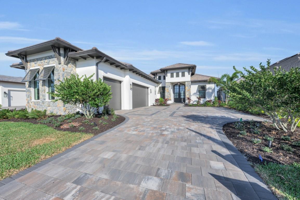 Lee Wetherington Homes Award Winning Cobalt fully furnished Model Home in Wild Blue at Waterside is now available for purchase and leaseback. Best Overall Winner at the 2024 Parade of homes, this stunning California classic inspired home is pure luxury filled with rich walnut tones, stone tile floors, and dramatic stained cypress ceiling details. Wild Blue is located in the Waterside Village of Lakewood Ranch. Residents will enjoy an exclusive resort-style clubhouse where a concierge service fulfills the desires of active and social lifestyles. The clubhouse will feature a theater, fitness studio, workout classrooms, golf simulator, billiards, an expansive pool complex with restaurant and patio bar, two swimming pools, a yoga lawn and putting green, Also enjoy miles of walking trails and the mid-way sport complex with 8 pickle ball courts, 6 tennis courts, Pro-Shop, dog park & playground. Landscape maintenance and irrigation included.
List price includes all furnishings, electronics and artwork and is net of the first 12 months leaseback.