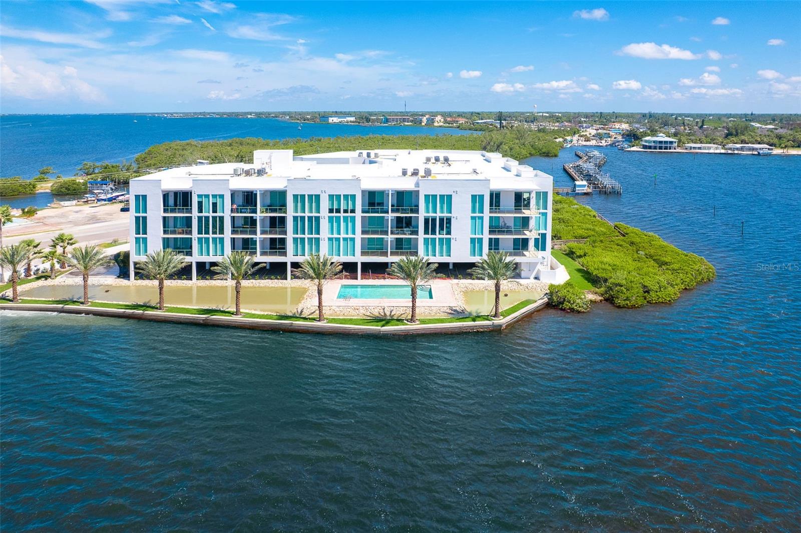 SPECTACULAR BAY VIEWS, ONLY ONE MILE TO THE BEACH, AND BOAT SLIP #21 WITH 10K LIFT - Enjoy the Gulf Coast lifestyle at Redfish Key Villas with easy access to the beaches of Manasota Key, Palm Island and Boca Grande. Experience world class fishing, boating, golfing and dining in the heart of Englewood and surrounding villages of Venice and Boca Grande. There is nothing quite like Redfish Key Villas with its unique setting at the water’s edge, superior construction, modern design, and upscale residences. This distinctive, open-concept, refreshed, second-floor residence delivers incredible views from nearly every room. Prepare to be wowed by ten-foot ceilings leading to incredible views of Lemon Bay and Redfish Cove through ten-foot, hurricane impact glass windows and sliding glass doors allowing natural light to pour in. The interior finishes include tile flooring in the main living areas, custom wood cabinetry with granite tops throughout, and luxury stainless appliances. Relax on your private balcony and enjoy endless views of osprey, dolphin, and manatee. Lounge by the heated pool or walk to local beaches, shops and restaurants. This stunning residence is ready for immediate enjoyment. Do not miss this opportunity! Several photos of similar residence are included to show furniture placement.