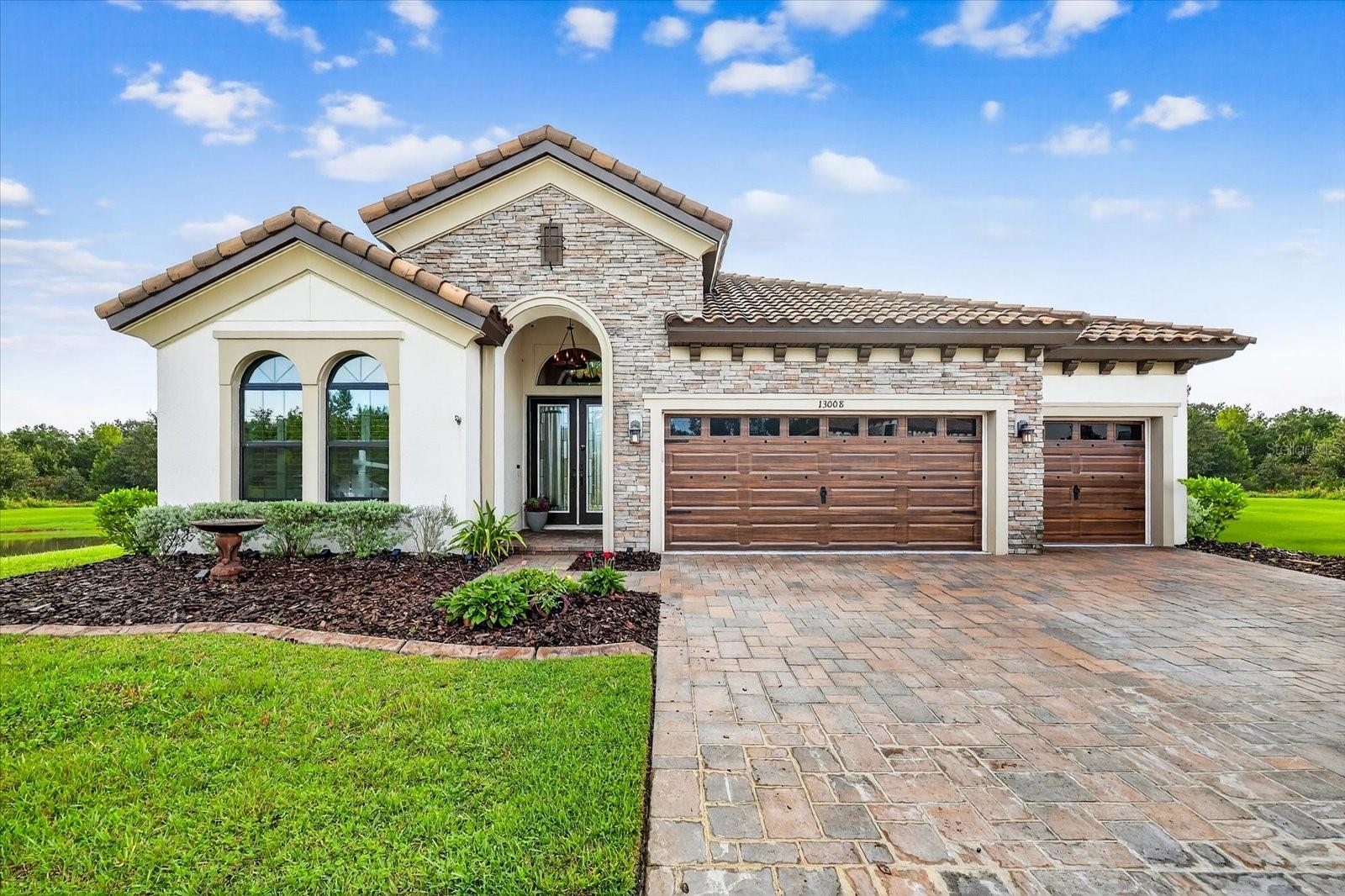 Once In a Lifetime Opportunity Awaits – Truly A “Unicorn”– Your Forever View Waterfront & Conservation, Corner/End Lot, Cul-De-Sac, Nearly New Home Loaded with Custom Upgrades, 2.5% Assumable VA Loan for Qualified Veterans, A-Rated Schools, Gated Community with Tons of Amenities, Act Now Before It’s Gone! You’ll fall in love with the privacy of this home and lot – nothing compares to this offering in any comparable community. Inside, stunning brick mason-installed Chicago brick feature walls line the kitchen, laundry room, and primary suite bathroom. The kitchen has top-of-the-line appliances, including a rare 48” built-in fridge, gas cooking appliances, and a farm sink. Additional owner upgrades include UV/privacy film on all windows/doors, two handmade sliding custom barn doors, designer lighting and paint, 5-mil luxury vinyl plank flooring installed throughout, closet built-ins, video/audio/camera smart technology installed that conveys, water softener, hanging rack storage in garage, and more! Located in the gated Hawkstone Artisan community, this home is zoned for the highly sought-after Newsome High, Barrington Middle, Pinecrest Elementary School. Builder options include five trayed ceilings, 10-12’ ceiling height, heavy crown and base trim, extended cabinets in the kitchen, upgraded cabinetry and quartz counters throughout, 24’ sliding glass door, extended lanai, and a deluxe oversized shower in the primary suite. The Biscayne is a fantastic open living floorplan, providing seclusion for the owner’s retreat and secondary bedrooms. The heart of the home is the combined grand room, gourmet kitchen, and casual dining area, with access to the outdoor living space featuring a large, covered lanai. 12-foot ceilings in the foyer, grand room, and kitchen complement the open design. Hawkstone residents enjoy resort-style amenities, including a lagoon pool with a splash pad, fitness center, dog park, community trails for walking, pickleball and bocce ball courts, playgrounds, and ponds. Community is located close to Triple Creek and Lithia Springs, with pet-friendly hiking at the 969-acre Triple Creek Nature Preserve, less than 2 miles south, or try bicycle motocross at Triple Creek BMX, 1 mile south of Hawkstone. This family-friendly neighborhood truly has it all!