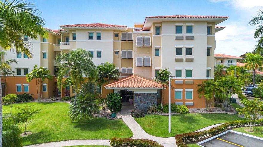 Penthouse residence distinguished by its high ceilings that create an open and airy ambiance throughout the main living areas. The added height enhances natural light and provides a greater sense of space and architectural presence.

The layout features two spacious bedrooms, each with its own private bathroom, plus a convenient half bath for guests. The living and dining areas flow seamlessly in an open concept design with direct access to a private balcony overlooking the lake. Enjoy peaceful water views, an ideal setting for morning coffee or relaxing evenings.

The property includes a full power generator for added reliability, a tele-entry access system, elevator service within the building, and two assigned parking spaces.

Located within Palmas del Mar, a gated master planned resort community offering 24 hour security, two championship golf courses, tennis and pickleball facilities, marina, beach club, restaurants, shops, and miles of golf cart and walking trails.

A unique advantage of this location is its proximity to both The Palmas Academy and the Palmas del Mar Equestrian Center, each approximately 700 meters away, making daily school commutes and equestrian activities exceptionally convenient.

A penthouse offering height, light, and privacy in one of Puerto Rico’s most complete resort communities, with excellent potential to tailor to your personal style.

Palmas del Mar HOA is 1,300 per year | The Woods HOA fee is $376.35 per month