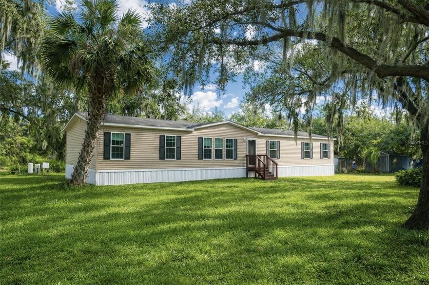 One or more photo(s) has been virtually staged. Welcome to 6102 Woodhaven Dr in Lakeland! This spacious double-wide mobile home offers 4 bedrooms, 3 bathrooms, and 2,052 sqft of living space with plenty of room both inside and out. The primary bedroom features a walk-in closet and an attached en-suite bathroom complete with dual sinks, a relaxing soaker tub, and a separate standing shower. Recent updates include new flooring. The property is serviced by a private well, helping reduce monthly utility expenses. Situated on a generous 0.94-acre lot, there is ample outdoor space for parking, storage, and activities. Schedule a showing today!

Some photos in this listing have been virtually staged to help illustrate the property’s potential. No physical changes have been made to the property.
