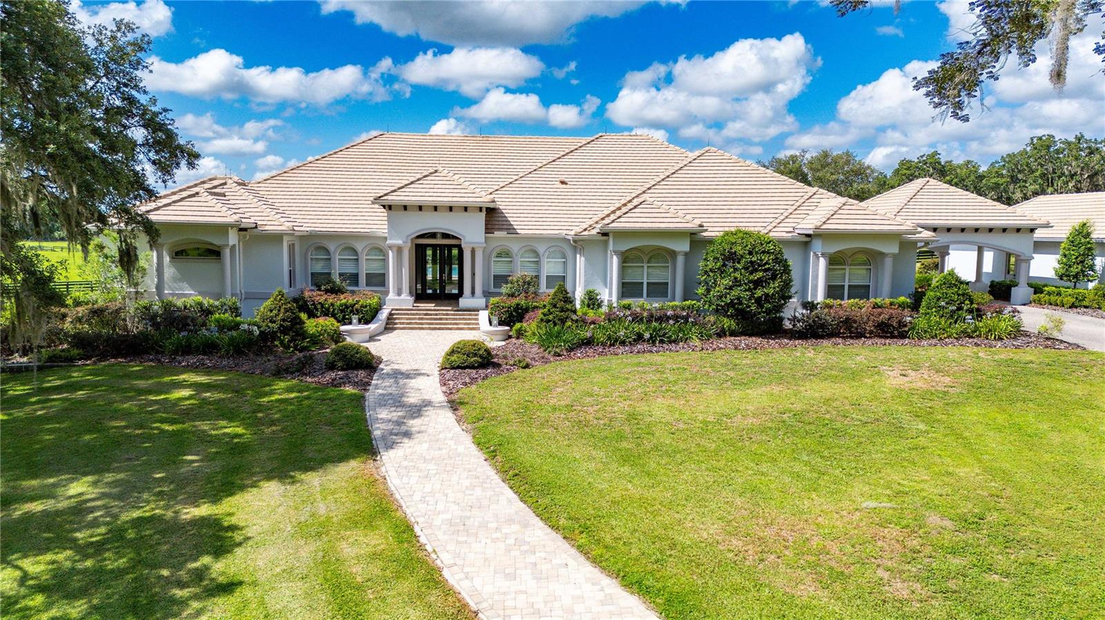 Your Dream Ocala Oasis only minutes from the World Equestrian Center! This custom home delivers it all. Situated on 20+ acres behind a smart, secure gated entrance, this stunning 4-bedroom, 4.5 bathroom estate has everything you need! Step inside to find spacious living areas and marble flooring throughout. The outdoor area adds to the wow factor, featuring a sparkling, smart, heated screened-in pool and hot hub and a fully equipped outdoor kitchen perfect for entertaining. Additional highlights include a steam room in the primary bedroom, a workshop for hobbies or extra storage, and a detached 2-car garage. This is one you don't want to miss. Schedule your private tour today!
Features and Upgrades:
Multi-zone irrigation on the property
Washer/Dryer in Primary Bedroom Closet
Steam room in Primary Shower
2 Tankless Water Heaters
Water Filtration + Softener System
Smart Home with automation
Alarm + HD Camera System
Home & Pool Area Sound System
No Climb Fence
Clean Artificial Turf Dog Run
Smokeless Breeo Fire Pit
Hot Tub with Therapy Jets
Screened-in Heated Smart Pool
Separate Electric Heater for Pool
Fully equipped Outdoor Kitchen
Gutters Around Home
Porte-cochère
Detached Multi-Car Garage with 220V Electric + Bonus Room
Spacious Workshop
1 Gig Internet in Home & Workshop