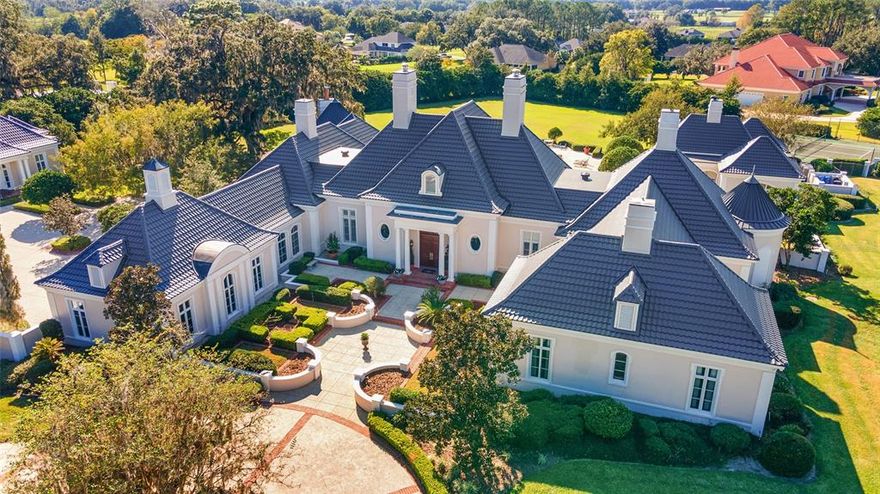 Exquisite 3.54 acre estate with 7867 sq ft main residence with 4 bedrooms/4 full baths and 2 half baths & 3 car garage, along with a 2/1 guest home with 2 car garage & a pool pavilion complete with kitchen, exercise room, bath and sauna. Elegant main residence features formal living room w/imported marble fireplace as its focal point, along w/16 foot ceilings. Formal dining room has built-in display cases for displaying china, crystal or other decorative items. The dining room leads to a butler's pantry with custom built cabinets and double sink. Beyond the pantry you enter into a gourmet chef's paradise with hanging pot/utensil rack, professional grade appliances, custom cabinetry and eat-in breakfast nook. Located just off the kitchen any wine connoisseur will appreciate the climate controlled wine room. The kitchen leads into family room with mahogany built-ins and adjoins a round billiards/game room with a fireplace at its center. Heading toward the master suite, you will find a mahogany paneled library w/fireplace, the master suite with sitting room and morning kitchen, along with his and hers closets and baths. All 3 other bedrooms have walk-in closets and ensuite baths. French doors from main home lead to pavered veranda leading to 2 bedroom/one bath guest house, complete with living room, dining area and full kitchen. A resort-like pool, spa and 1000+ sq ft pool pavilion w/fully equipped kitchen, sauna and gym and a tennis court complete this luxurious estate.