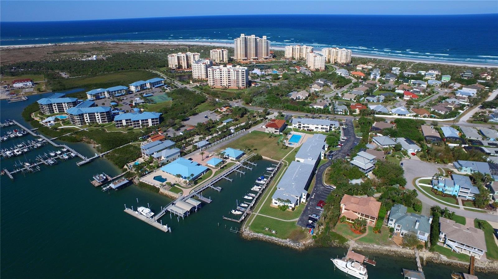 Beautifully furnished turn-key three bedroom two bath condo with views of the intracoastal waterway and an abundance of luxury amenities. The unit boasts ample living space with dining space and a breakfast nook, AC is 2024, impact windows throughout, quartz countertops, and a spacious covered balcony. The unit conveys with an assigned garage parking space. The Palms Association diligently maintains the building and boasts excellent financial health and reserves. Minorca community offers private beach access and river access with kayak launch/storage and a fishing pier. The marina occasionally has boat slips for sale, all deep water and meticulously maintained docks. Steps to Smyrna Dunes Park and the inlet, truly a spectacular North Beach location.